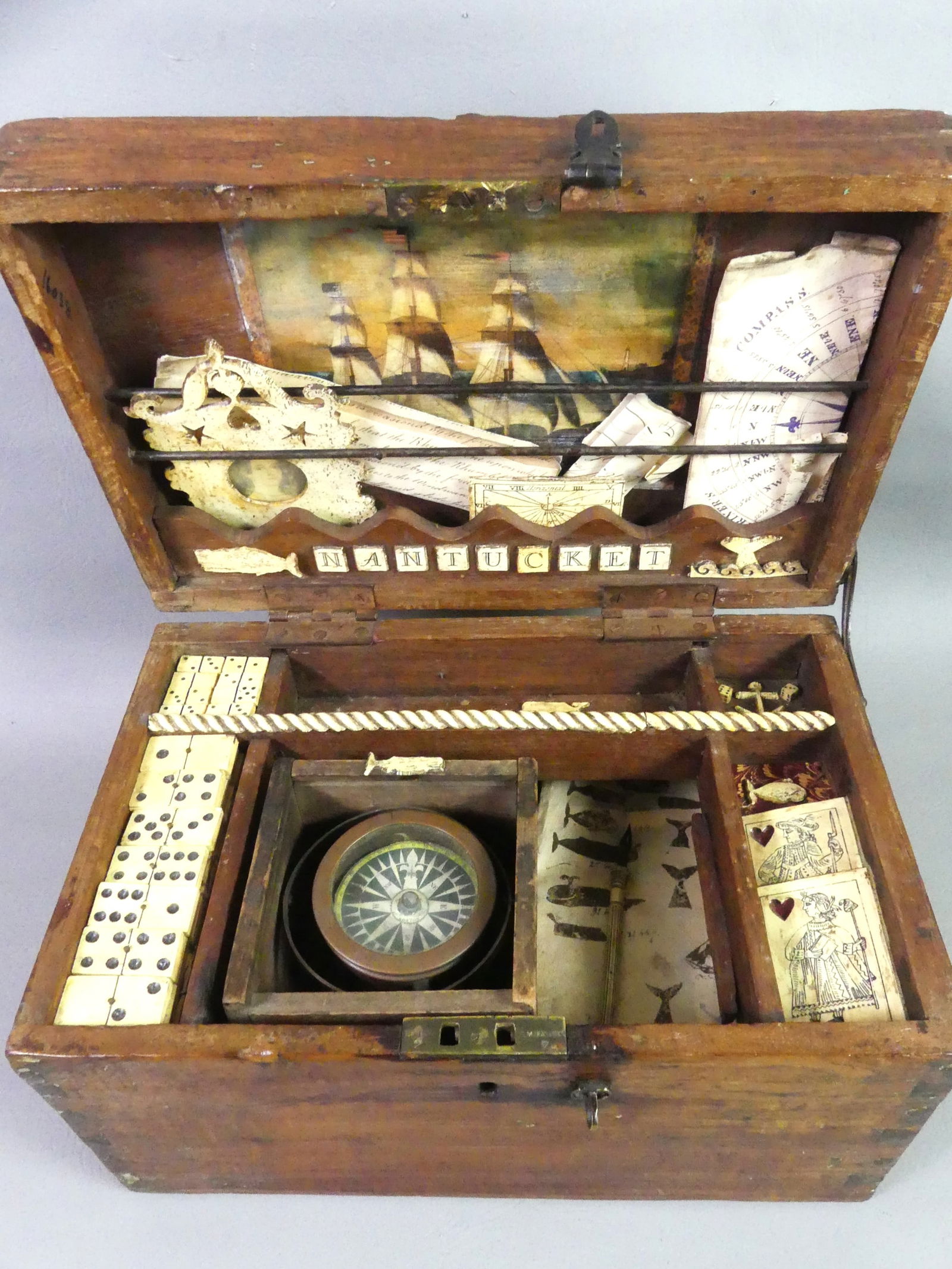 NANTUCKET WHALING CAPTAIN'S FANTASY WHALE BONE BOX: Wonderful vintage wood and faux whale bone Nantucket whaling captain's dovetailed fantasy wood box with an assortment of scrimshawe items including dominoes, playing cards, picture frame, whales, dip