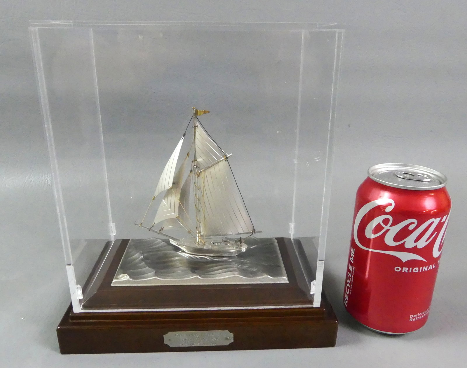 STERLING SILVER YACHT MODEL: Sterling silver boat model ONE MAST YACHT 422/1800 (.960 silver) mounted on wood base with plexiglass cover. Boat is 4.5 in tall. Waves are silver plated. Has Japanese maker name on base. Overall size
