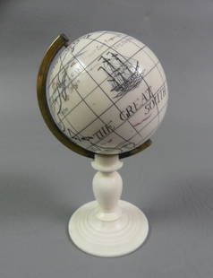 MINI SCRIMSHAW BONE GLOBE OF EARTH: Miniature carved bone globe of the earth on stand with scrimshaw map, whales, and ship. 3.5 in high and 1.75 in diameter.
