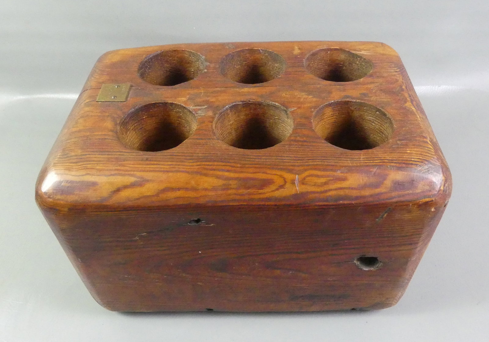 ANTIQUE SHIPS WINE BLOCK - BOTTLE HOLDER: Heavy antique carved wood ship's bottle holder stamped --Tredegar Iron Works, Wine Block--in heavy pine with 6 tubes and brass plaque #25. 19 x 13 x 12 inches. Weighs 48 lbs.