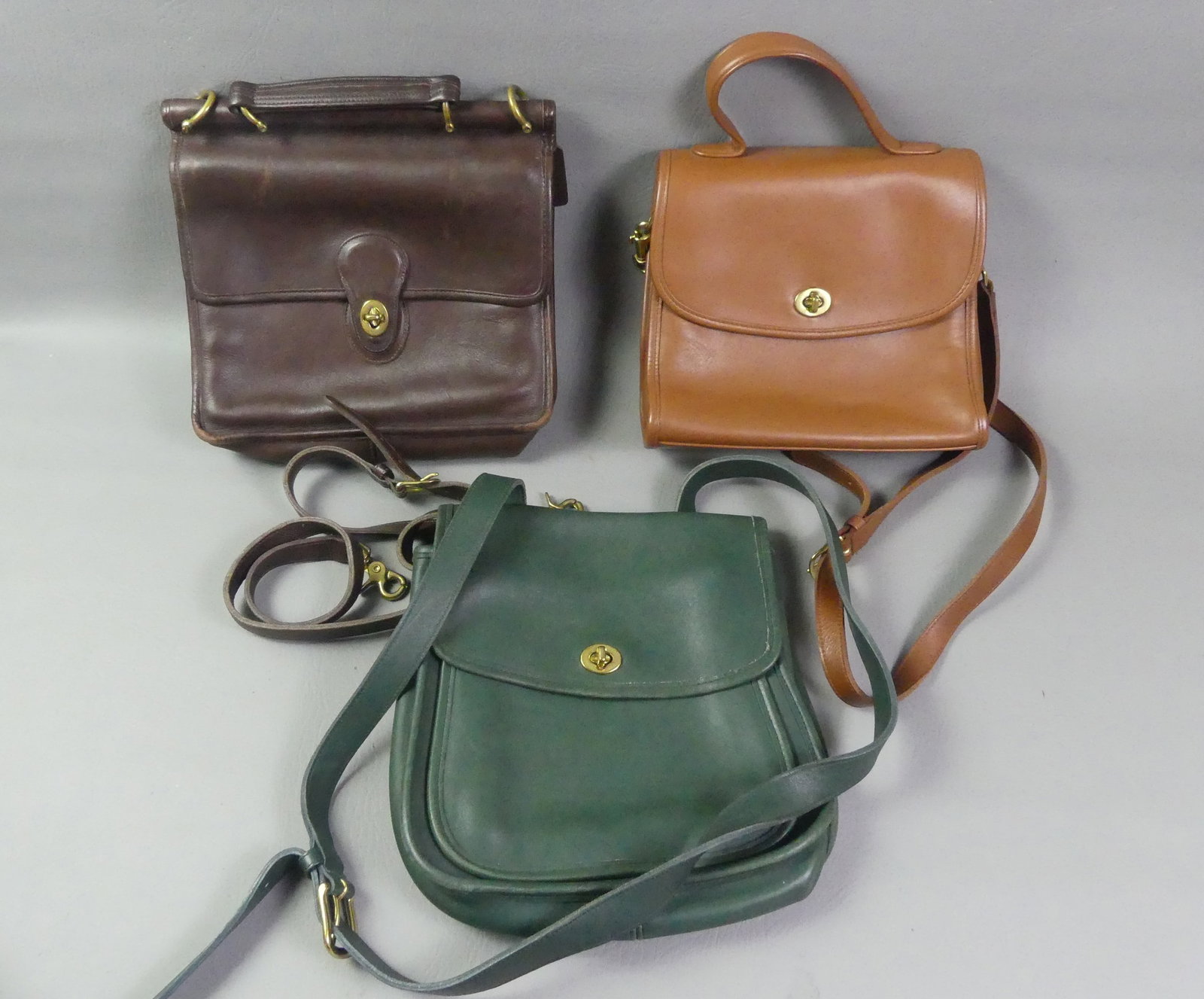 3 VINTAGE COACH BAGS: Lot of 3 vintage Coach leather bags - tan, brown, and green. All have serial numbers inside, 2 with tags. VG condition.