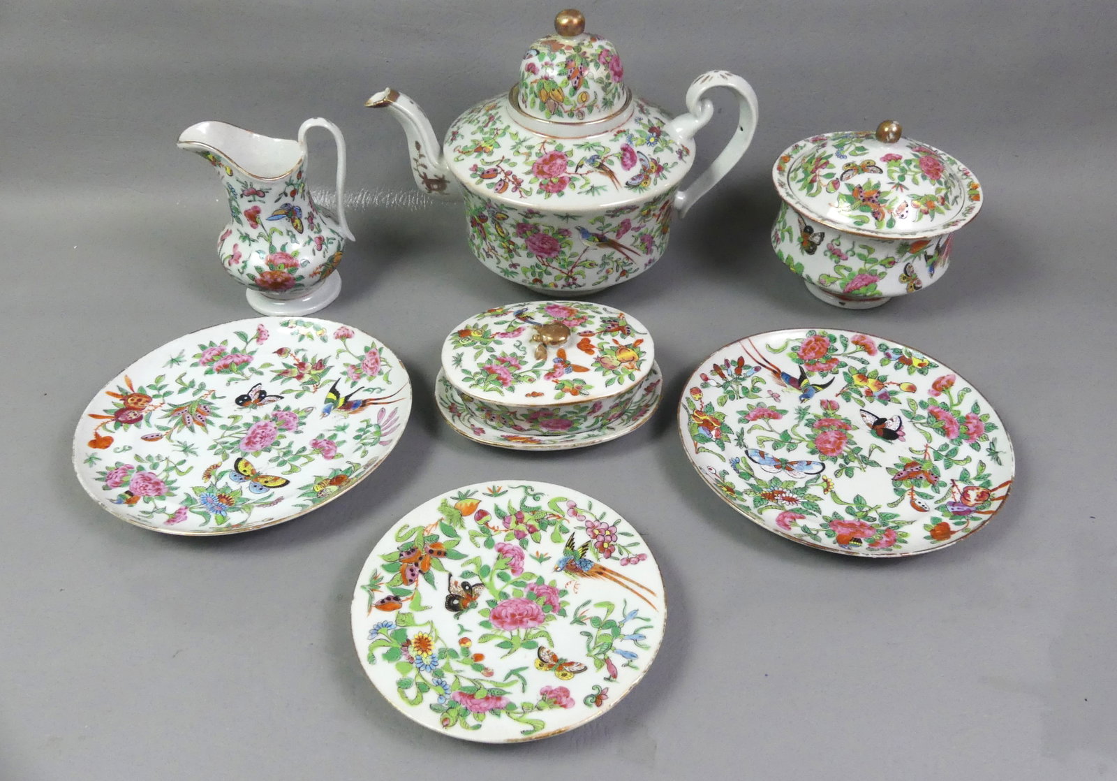ANTIQUE CHINESE FAMILLE ROSE TEA SET ETC.: Group of antique Chinese Famille Rose decorated ceramics including a tea set circa 1850 with 8.5 in dome teapot (repair to lid, base good); large covered sugar and creamer; 6 in oval butter dish with 