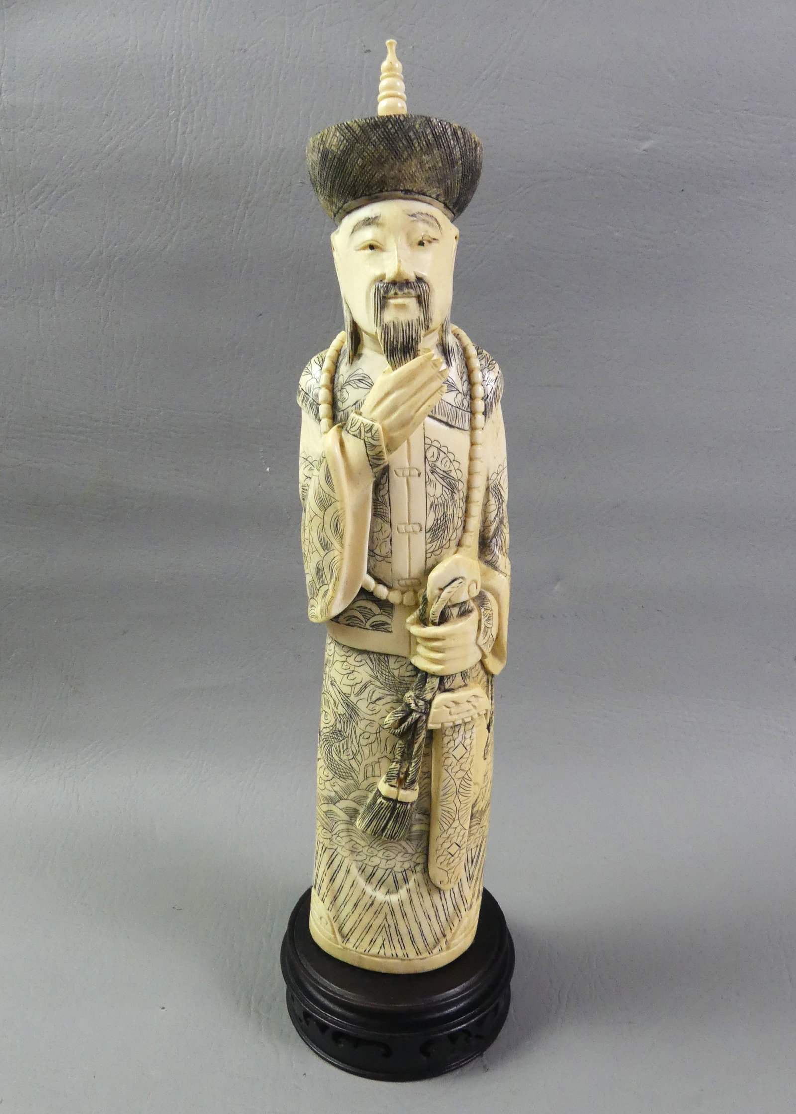 CARVED BONE CHINESE SCHOLAR FIGURE: 19th century finely carved bone figure of a Chinese scholar, signed on underside. 12.5 in tall plus 1.5 in high wood base. VG condition.