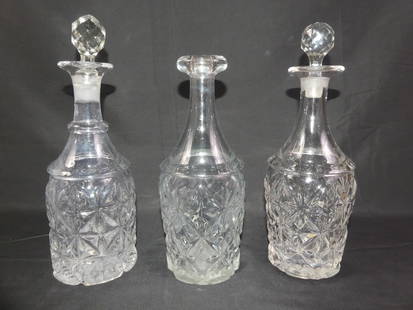 3 SANDWICH GLASS DECANTERS: Lot 3 early Sandwich Glass heavy decanters in the Star/Quarter Diamond pattern. One has thick rolled top (no stopper), other 2 have replacement stoppers. VG condition on bottles, stoppers have chip on