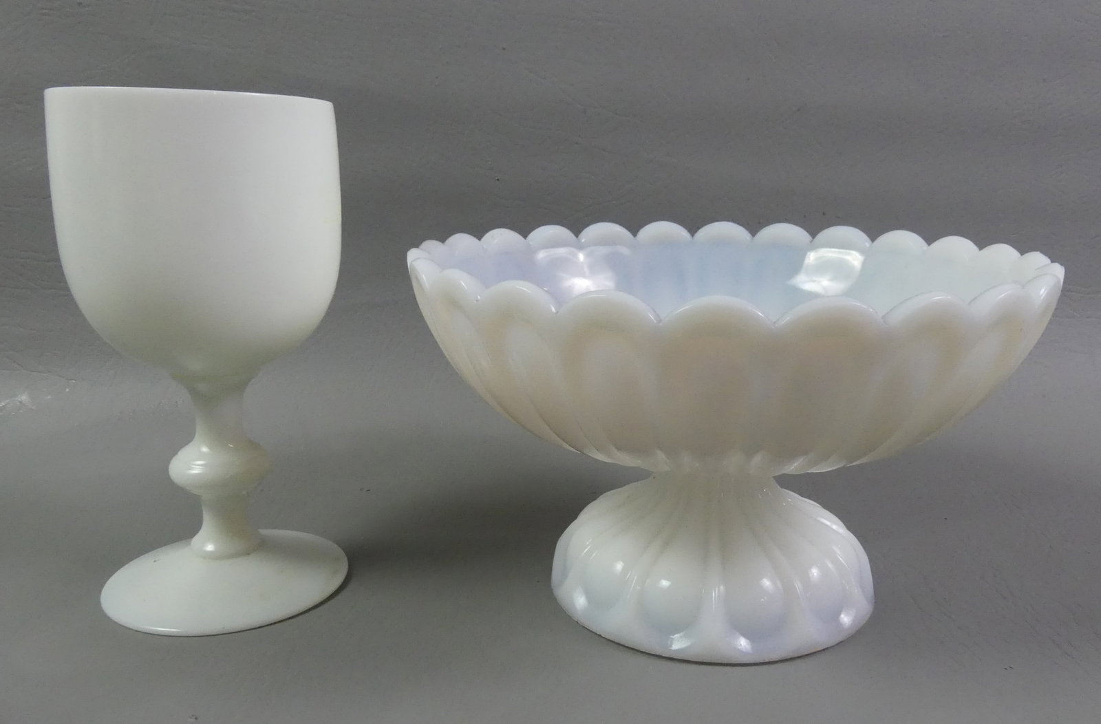 2 SANDWICH MILK GLASS PIECES: Lot 2 Sandwich colored items in milk glass: 8 in scalloped and footed bowl, 4.75 in tall; and 6.5 in blown goblet with paneled designs.