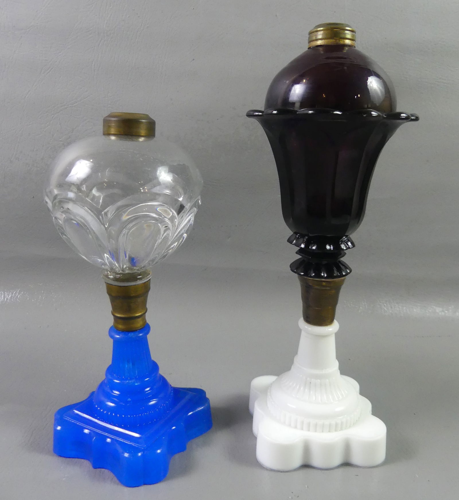 2 COLORED SANDWICH WHALE OIL LAMPS: Lot 2 Sandwich whale oil or fluid lamps to 7.5 in tall: amethyst font and milk white base (perfect) and 10 in tall blue with colorless font in Loop pattern (internal crack and repair to base).
