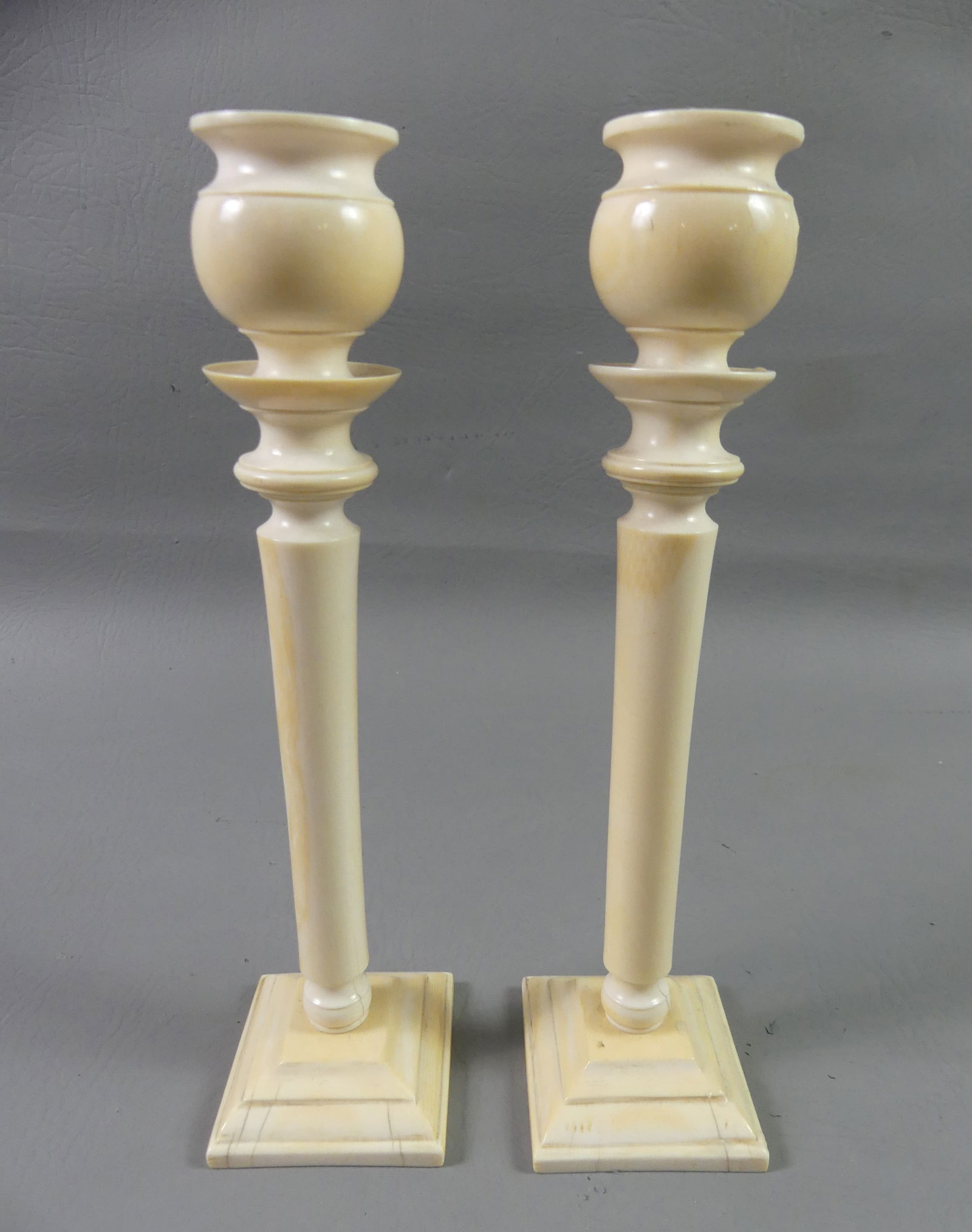 PAIR BONE 9 INCH CANDLESTICKS: Pair scarce antique carved bone candlestick holders, 9 in tall. Base is 2.5 in square. Good condition.