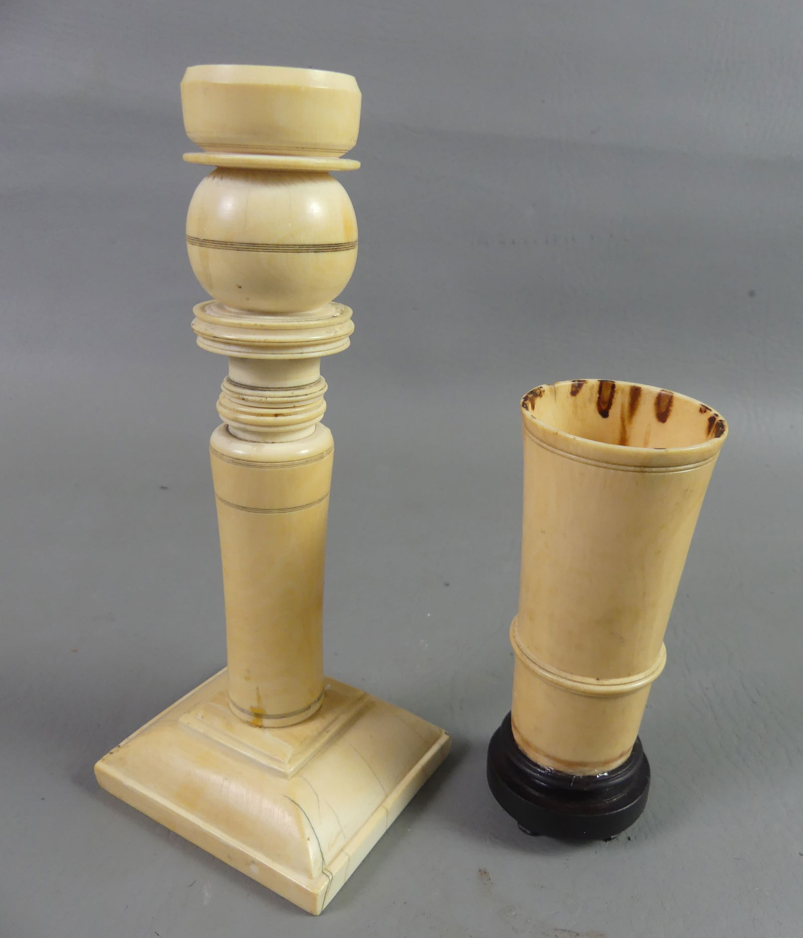 BONE CANDLESTICK & VASE: Two nineteenth century carved bone items: 7.5 in tall turned candlestick; and 4.5 in small vase on wood base.