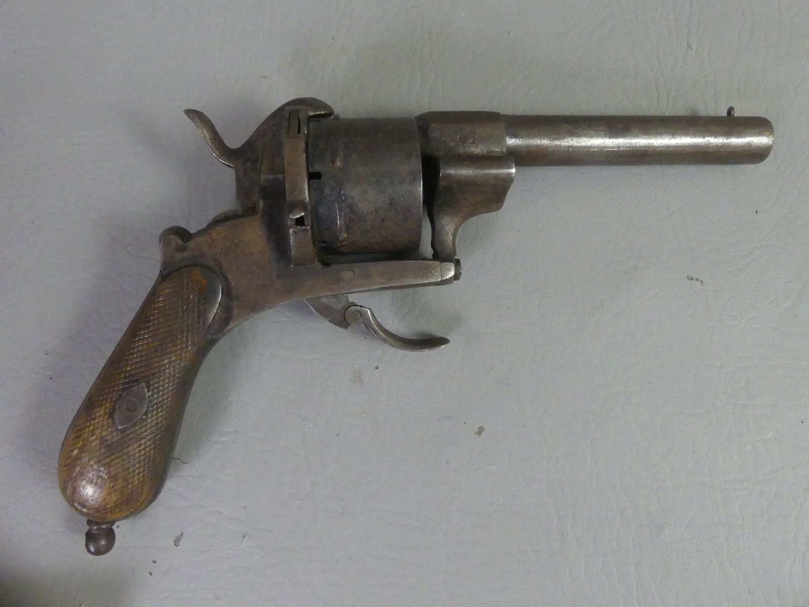 ANTIQUE PINFIRE REVOLVER: Antique pinfire 6 shot revolver attr. French, no marks, 10 in long, barrel is 4.75 in. About 38 caliber. The trigger pushes forward to load next bullet, good mechanics. Similar pinfire guns were used