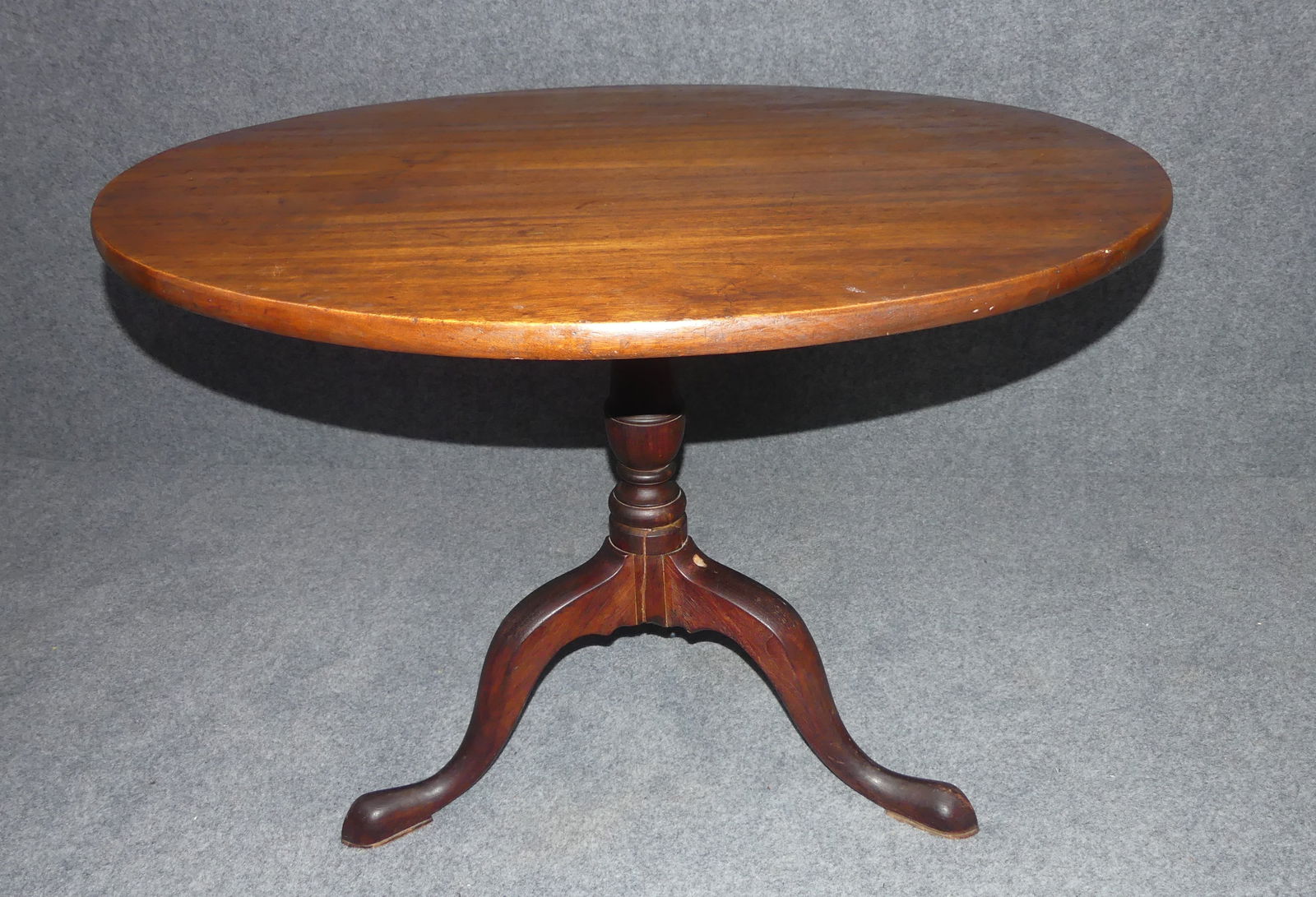 ANTIQUE MAHOGANY TILT TOP TABLE: Antique mahogany Queen Anne tilt top round table, 36 in diameter. Has tripod legs with pad feet. Has repair to cracks on column.