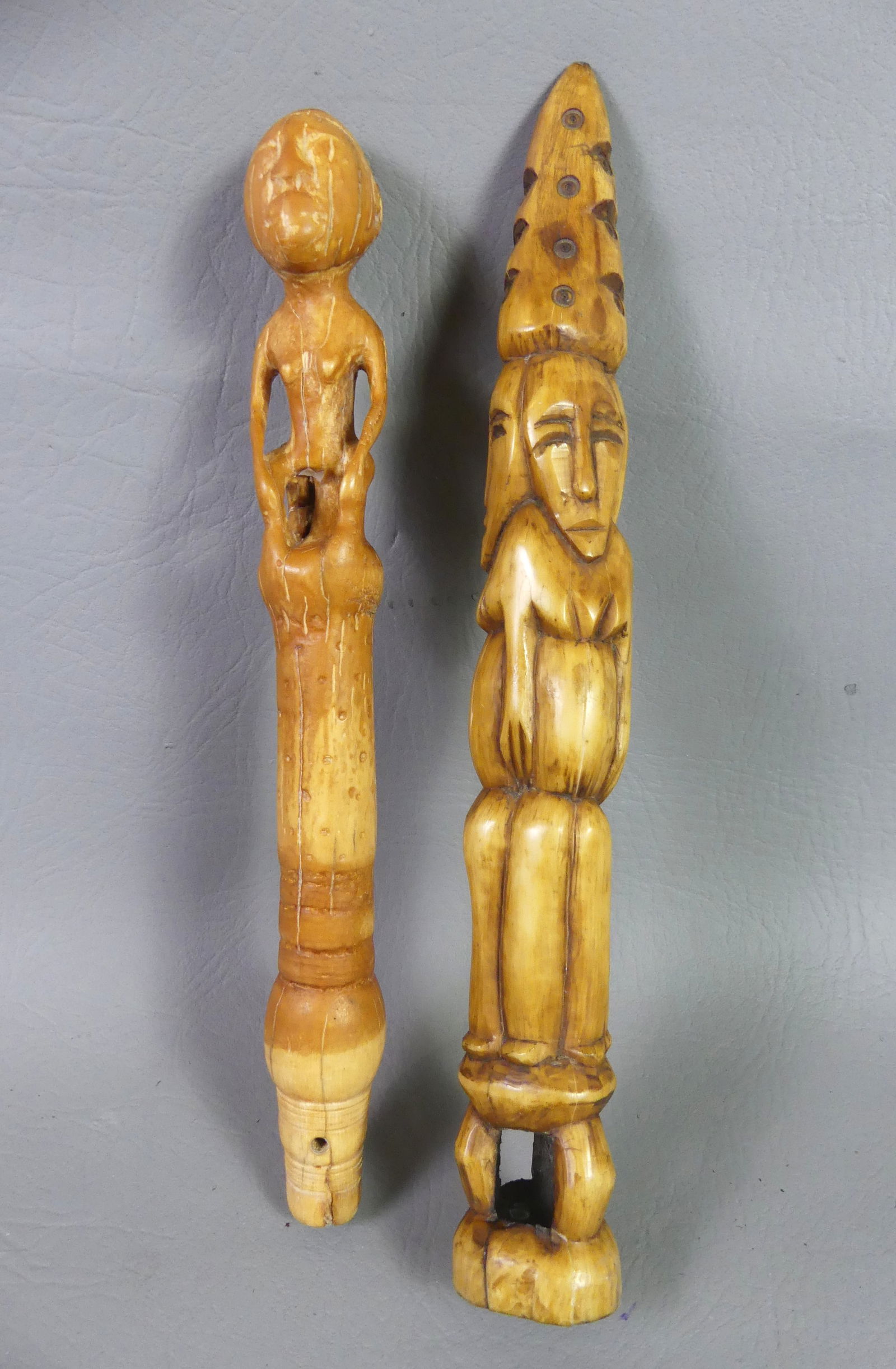 2 AFRICAN CARVED BONE ITEMS: Lot 2 African carved bone items to 11 in: Three-faced totem and a broom or staff handle with seated man .