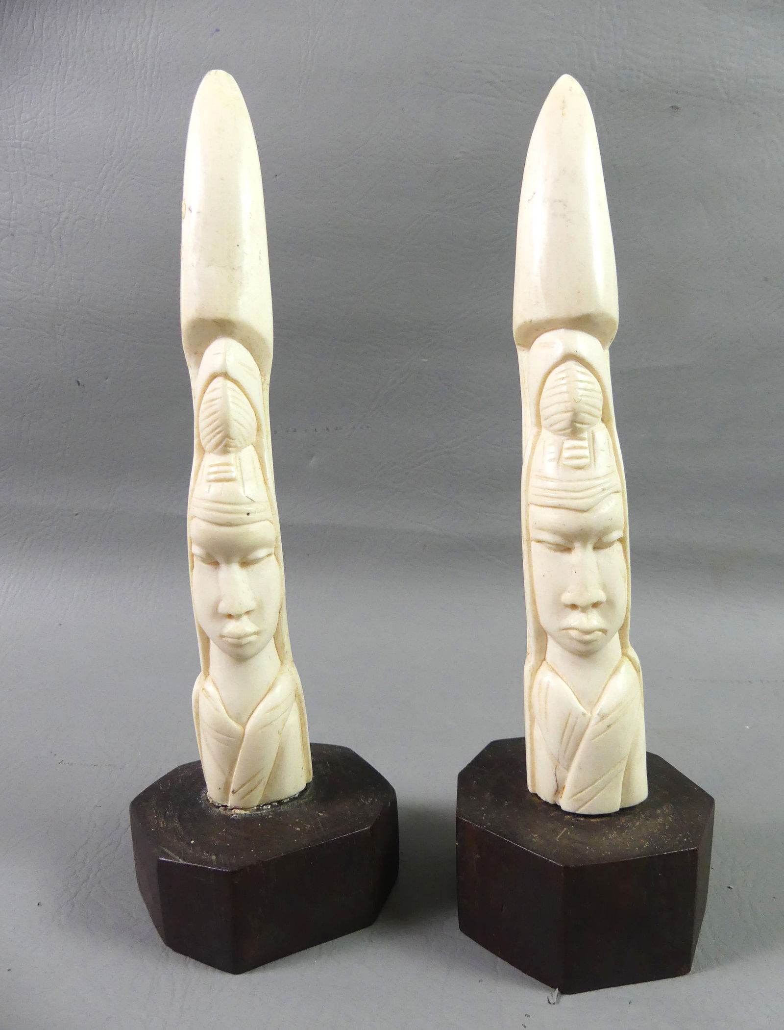 PAIR AFRICAN BONE FIGURES: Pair of African carved bone figures of women, 9 in tall x 1.5 in base.