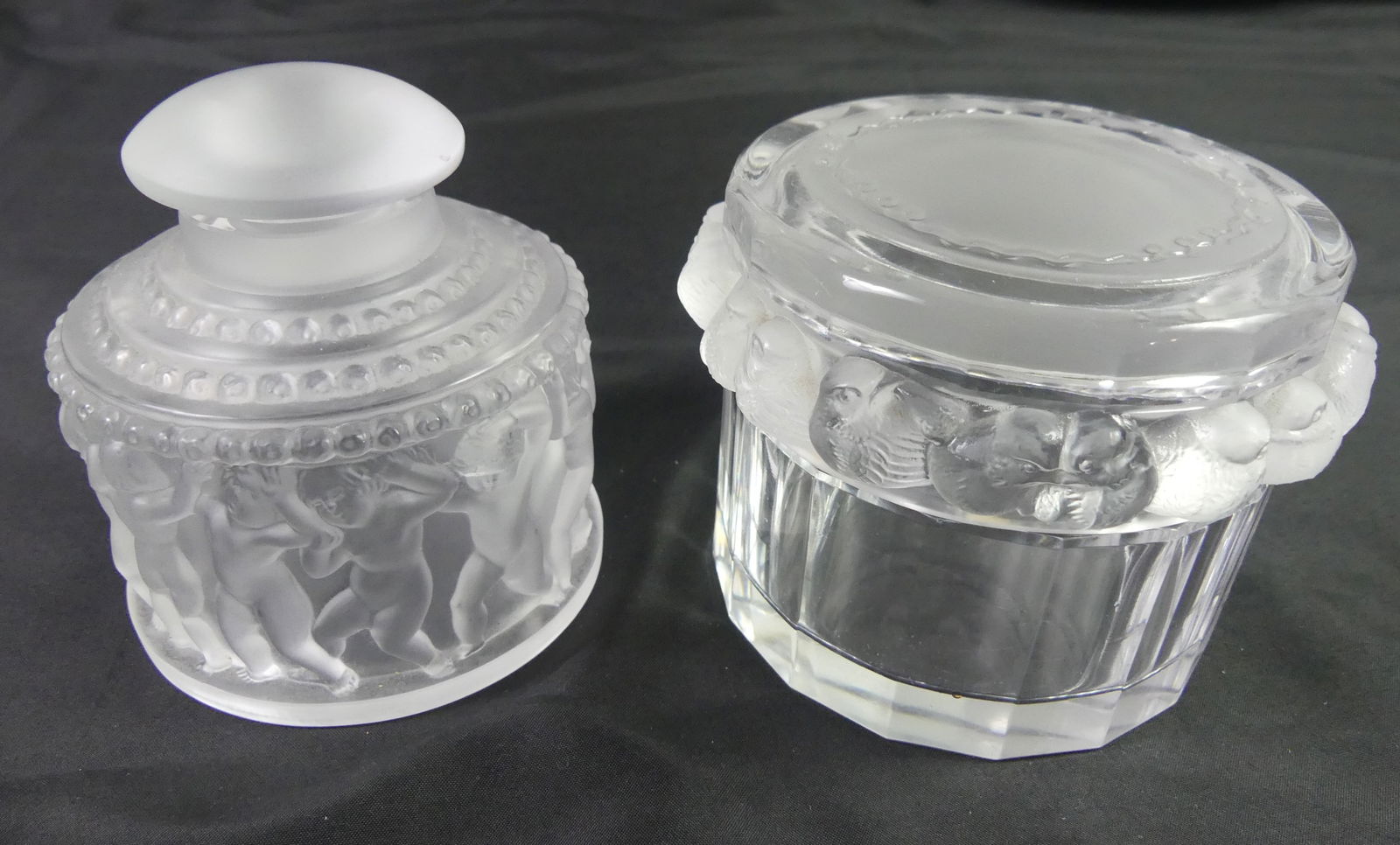 2 LALIQUE DRESSER JARS: Two vintage Lalique crystal dresser jars: 4 in perfume or cologne with frosted sparrows (Robinson Mesanges) and 3.5 in powder jar with frosted nude cherubs (Les Enfants). Both with engraved Lalique Fr