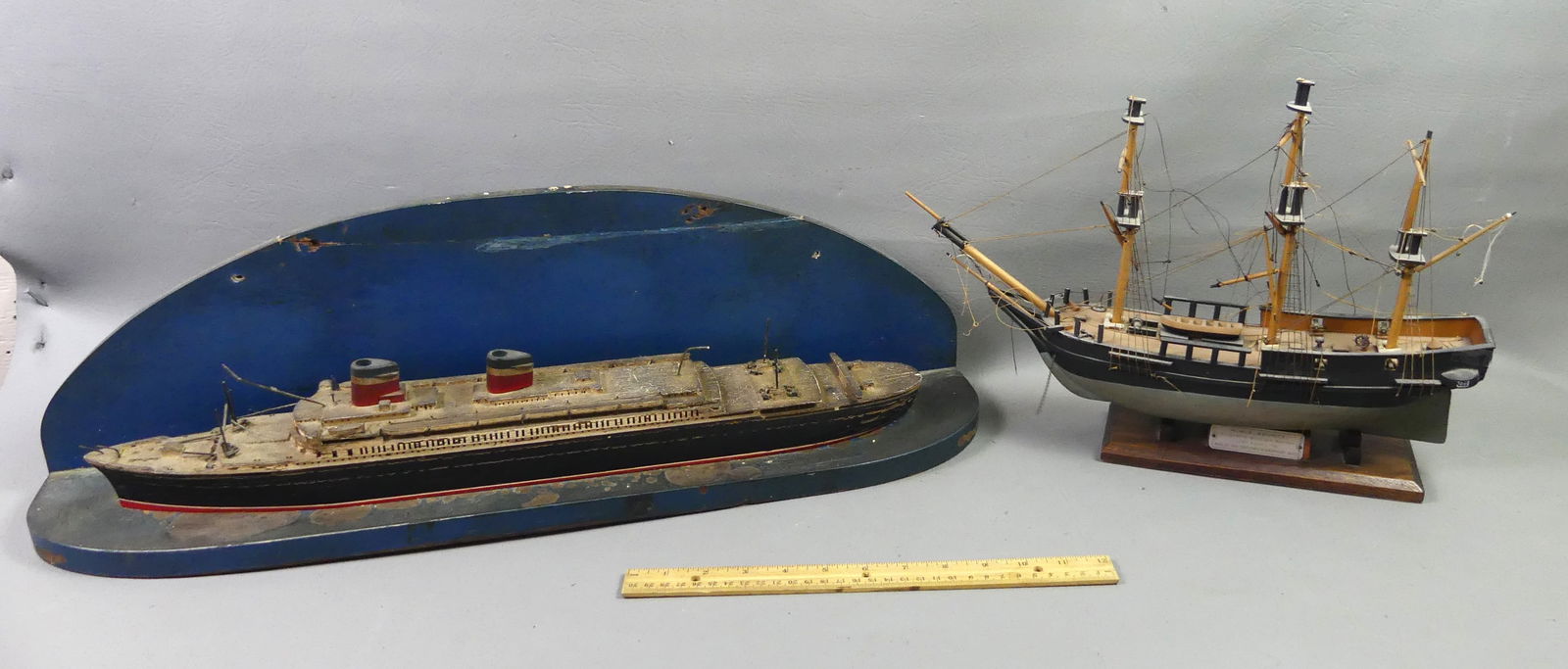 2 OLD SHIP MODELS - LINER & HMS BOUNTY: Lot of 2 old painted wood ship models: HMS Bounty, 16 in long x 11 in high signed Piel Craftsmen, Newburyport, Mass (top of 2 masts snapped off but intact); and an ocean liner with curved wood plaque,