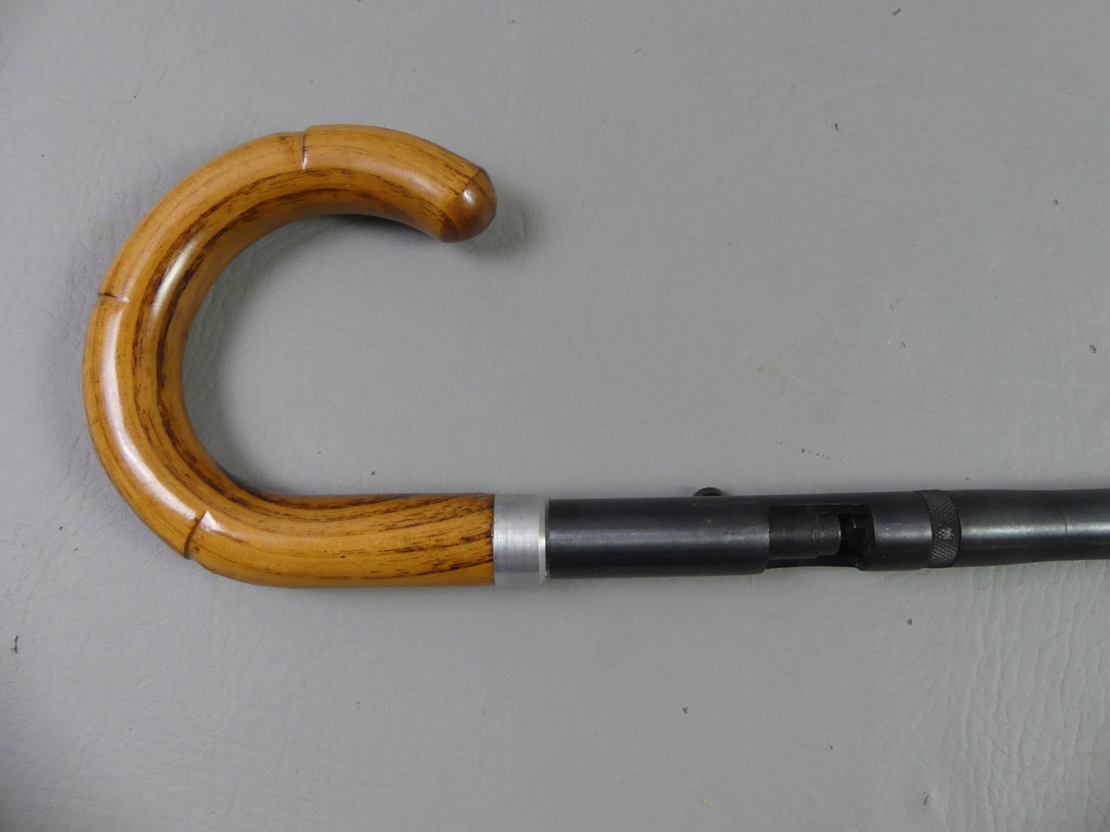 ANTIQUE GUN / RIFLE CANE: Antique gun or rifle cane with oak shepherd's hook handle, steel shaft, about 50 caliber. 35.5 in long. NOTE: We can ship this item in-house