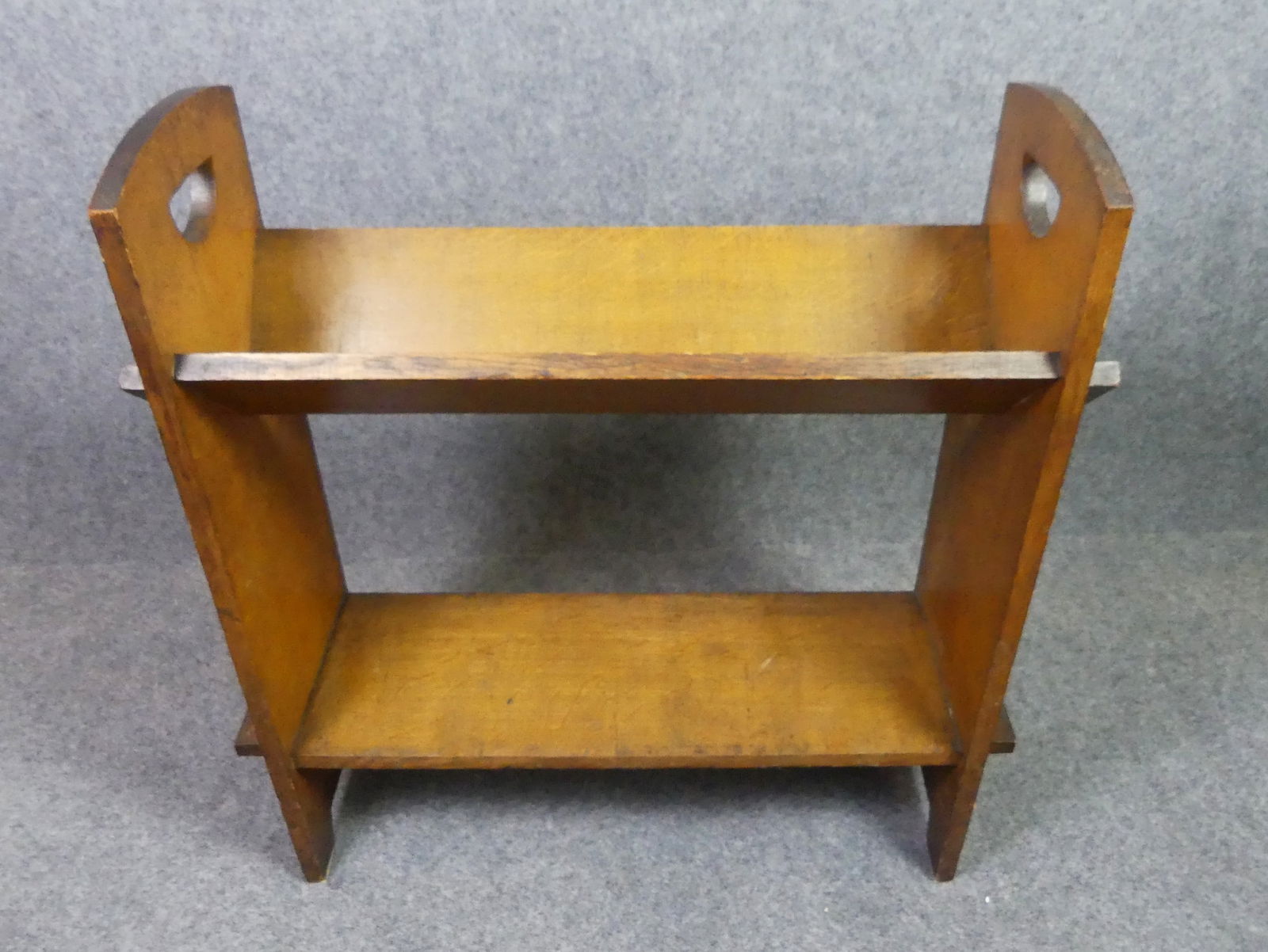 GOLDEN OAK BOOK TROUGH: Arts and Crafts period golden oak book trough, unsigned. 31 in high x 27.5 w x 10 in deep.