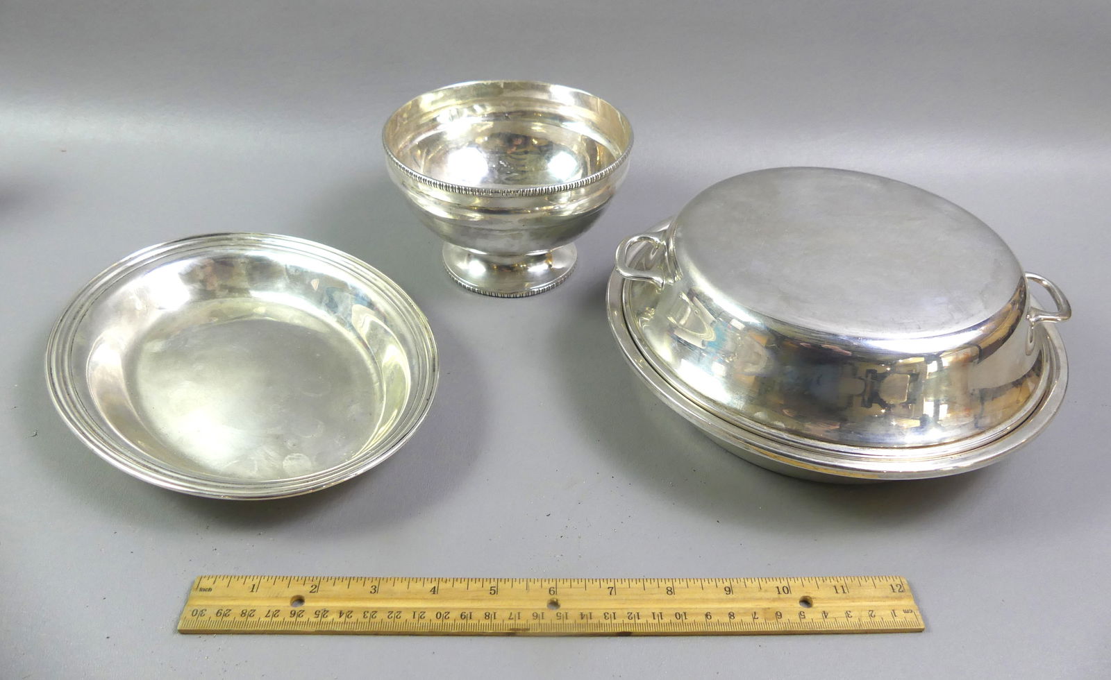 3 STERLING SERVING PIECES INCL. TIFFANY: Lot of 3 sterling silver serving pieces: Tiffany & Co. covered and handled round bowl, 9.5 in; oval bowl 9.5 in; and footed bowl 6 in diameter. Total weight 47.07 ozt.