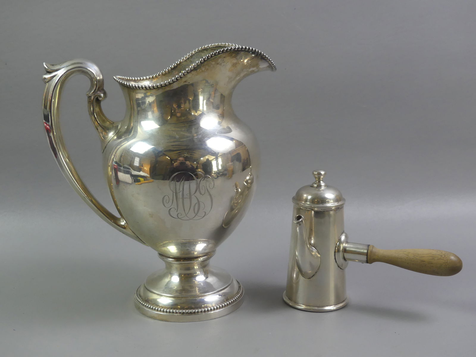 STERLING PITCHER & SANBORN POT: 2 sterling silver items: Reed and Barton 10 in tall beaded water pitcher with monogram; and Sanborn of Mexico side-handled pot with wood handle (no monogram), 5.5 in tall. Total weight 35.63 ozt.