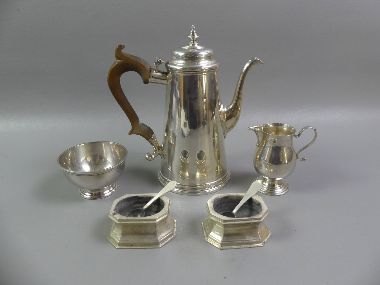 LOT STERLING SILVER TABLE ITEMS: Lot of sterling silver items: Ensko of NY 8.5 in teapot with wood handle; Ensko creamer and sugar bowl; pair Ensko open salt cellars; and pair of English hallmarked salt spoons. No monograms, heavy