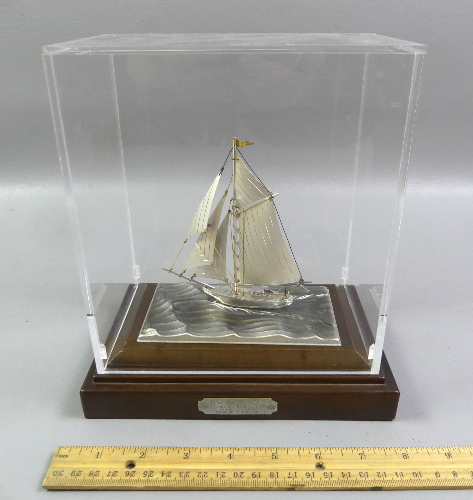 STERLING SILVER YACHT MODEL: Sterling silver small model of a yacht, mounted on wood base with plexiglass cover. Titled One Mast Yacht signed Seki, limited edition #422/1800. Overall 8.5 x 8 x 5 inches.