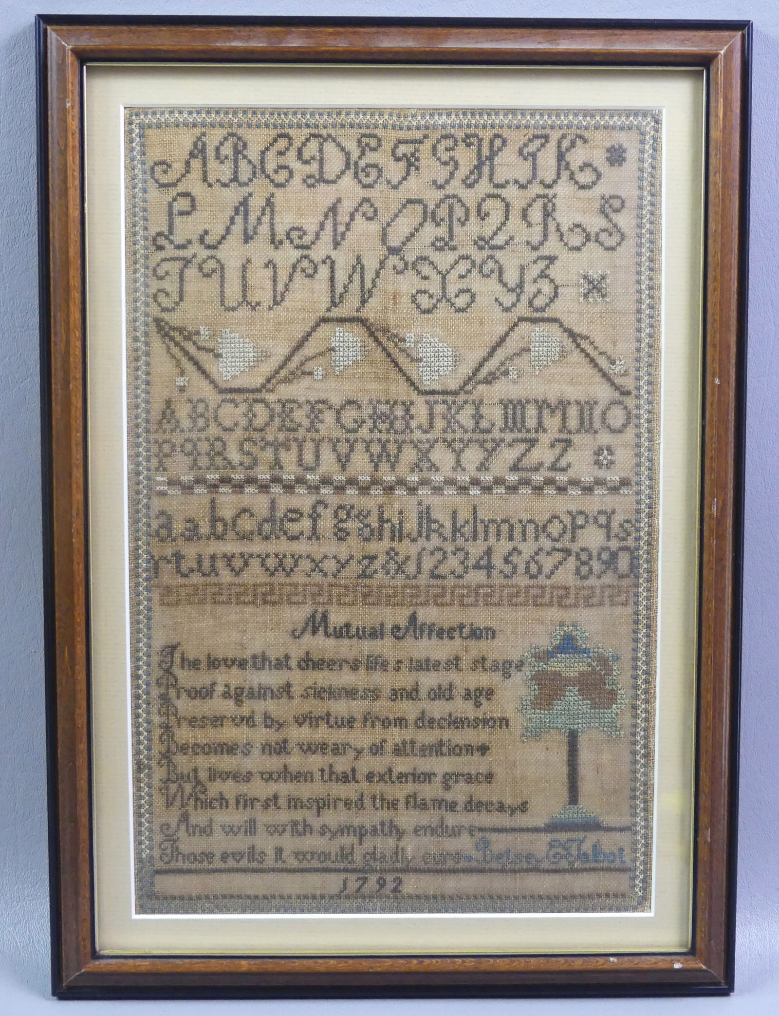 1792 SAMPLER BY BETSEY TALBOT: Framed Anglo-American sampler dated 1792 by Betsey E. Talbot. Includes the alphabet, poem, and a tree. VG condition. Overall size 15 x 10.5 in framed. NOTE: We can ship this item in-house.