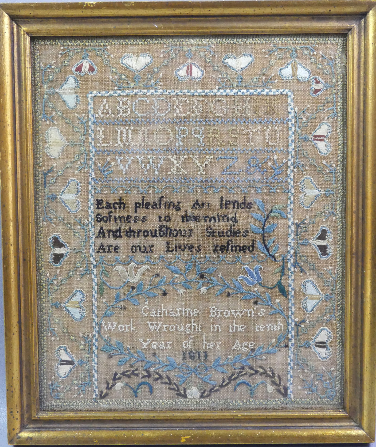 1811 SAMPLER BY CATHARINE BROWN: Framed Anglo-American sampler dated 1811 by Catharine Brown in her 10th year of her age. Includes the alphabet, poem, and hearts. Overall 13.5 x 11.5 in framed. VG condition. NOTE: We can ship this