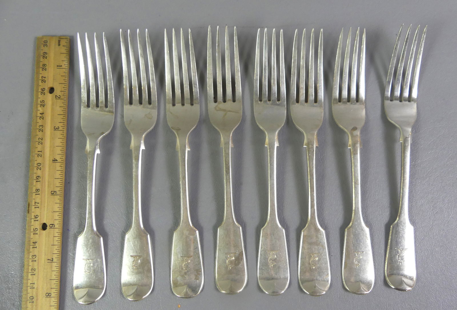 8 ANTIQUE ENGLISH STERLING FORKS: Set of 8 heavy English sterling silver forks, hallmarks for London, GA maker (George Adams), 1867. Engraved coat of arms on handle. Total weight 20 ozt. NOTE: We can ship this item in-house.