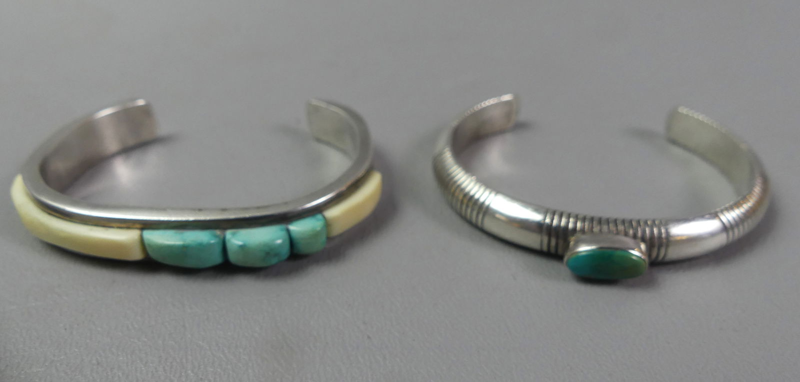 2 NAVAJO CUFF BRACELETS: Lot of 2 old sterling silver Navajo cuff bracelets: both 3/8 in wide, one set wtih single turquoise stone (unsigned) and other set with 5 gemstones and stamped with IS hallmark. Total 2.44 ozt. NOTE: