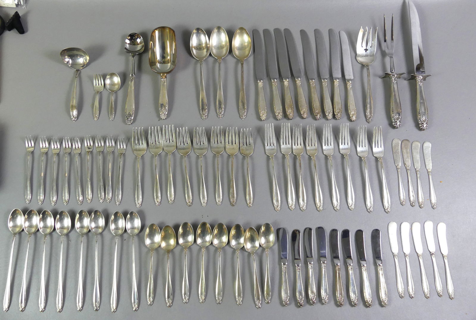 INTERNATIONAL PRELUDE STERLING FLATWARE SET: Set of sterling flatware by International in the Prelude pattern (not monogrammed). Consists of 8 dinner forks, 8 dinner knives, 8 luncheon forks, 9 solid butter knives, 8 butter knives with