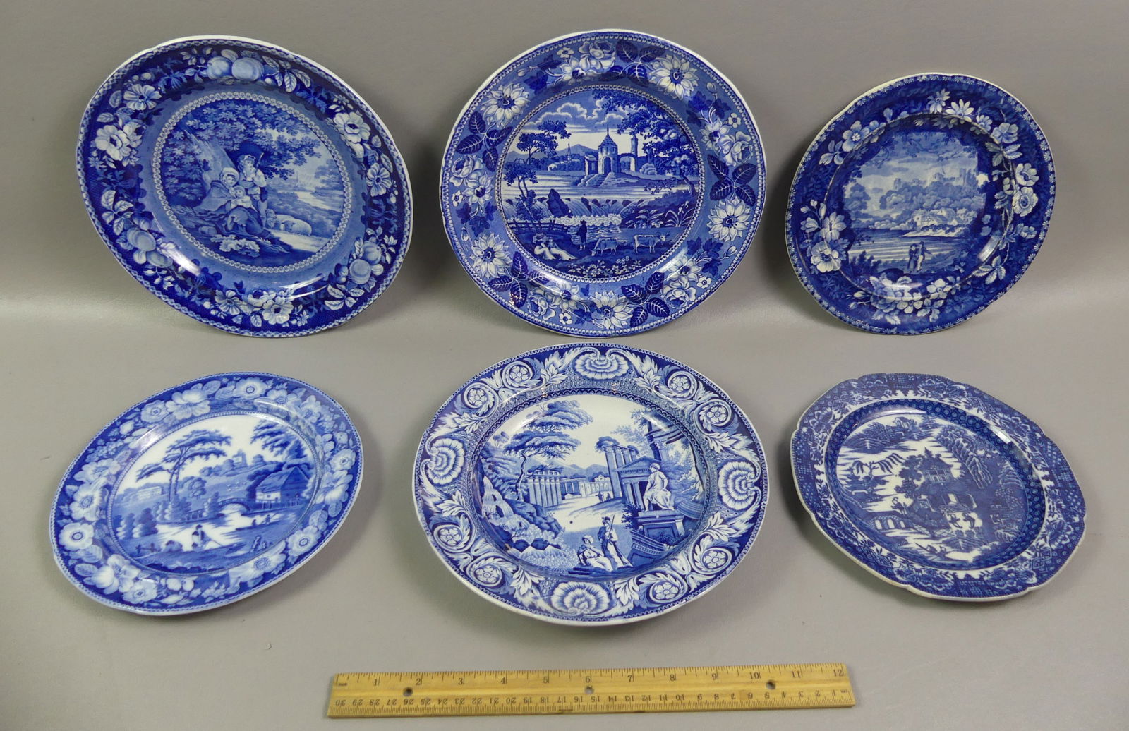 6 STAFFORDSHIRE BLUE PLATES: Lot of six 19th century deep blue and white Staffordshire transfer decorated plates: Tams Anderson 8.5 in with couple and castle; 8 in Wild Rose pattern with bridge and village; 8 in Blue Willow with