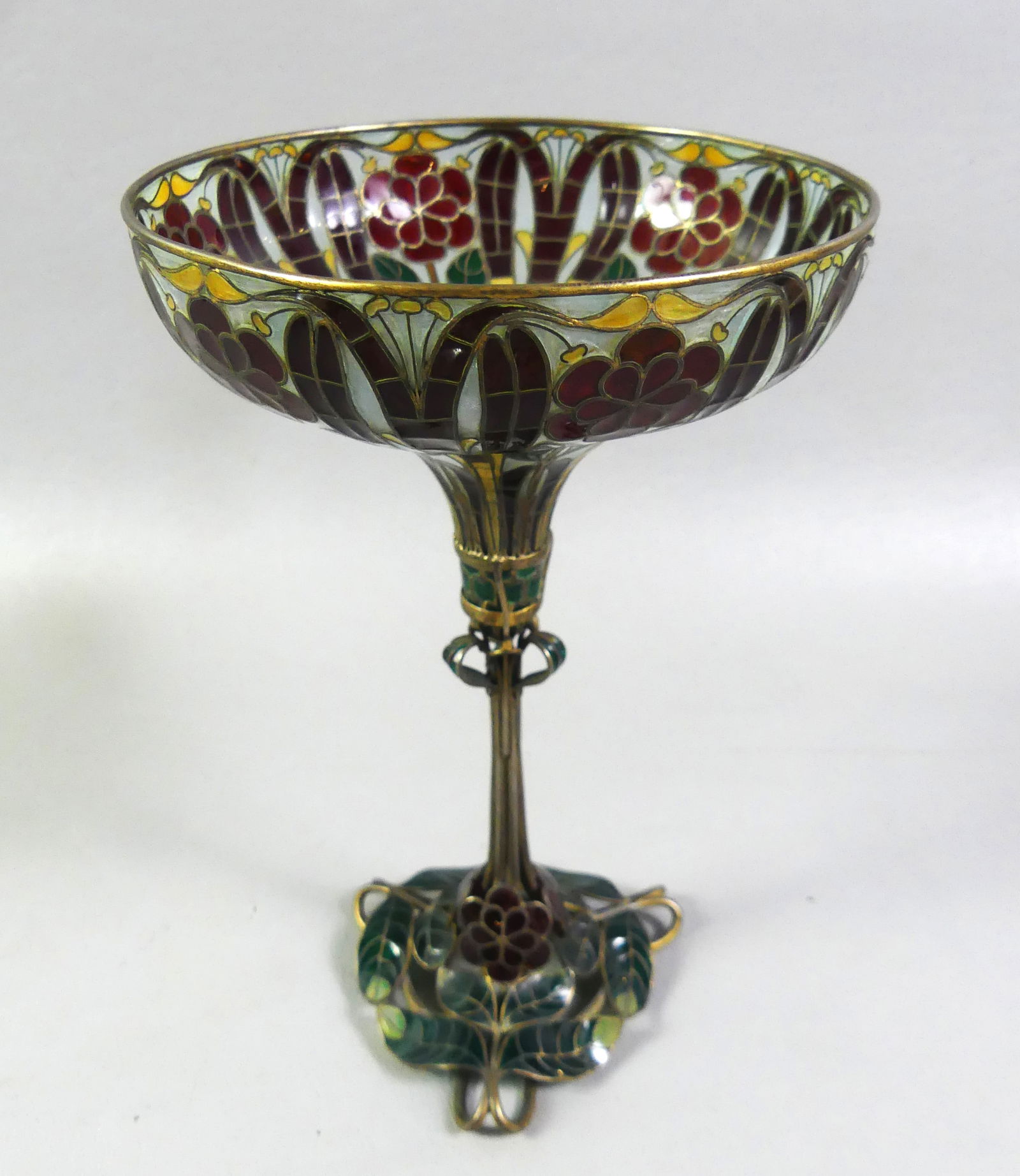 IMPORTANT FRENCH PLIQUE A JOUR VASE: Rare French Art Nouveau brass and enamel plique-a-jour vase with colorful floral design mimicking stained glass. Size: 7 in tall and 4.25 in across mouth. In good condition with one small green petal