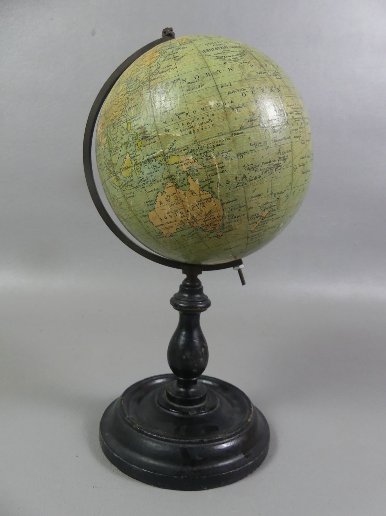 PHILIP'S MINI DESK GLOBE: Circa 1900 desk globe on wood stand signed Philip's 6 in Terrestrial Globe, London. 11 in tall overall. Good condition. NOTE: We can ship this item in-house.