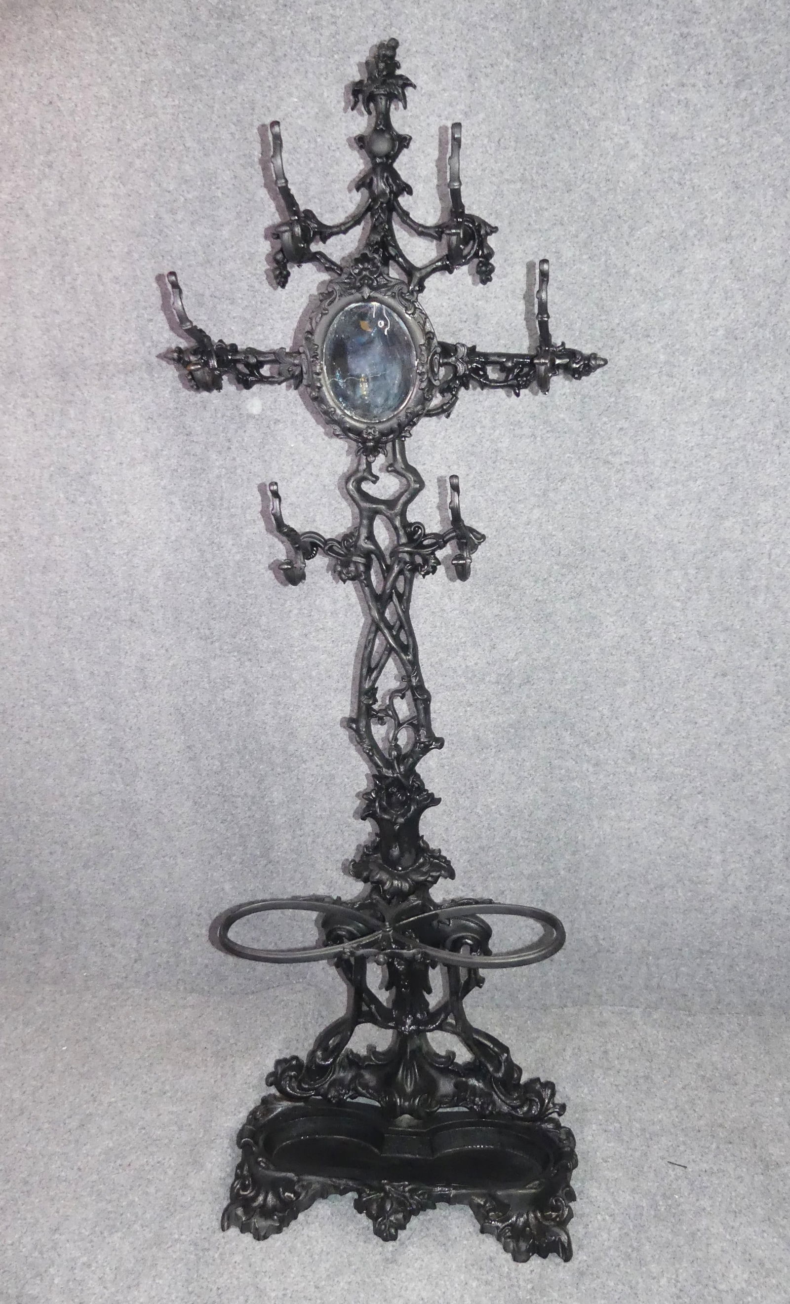 VICTORIAN IRON HALL TREE: Fancy Victorian cast iron hall tree with mirror and removable lower cane/umbrella tray. Also has hooks for hats. 79 in tall x 29 w x 14 d. VG condition.