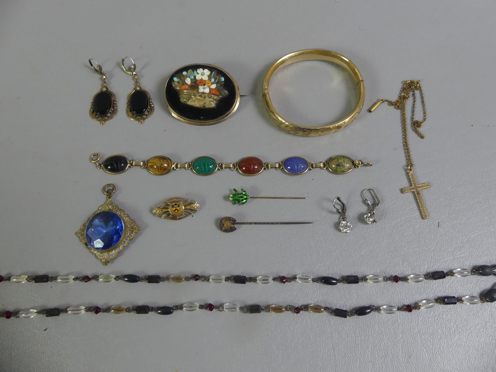 LOT GOLD FILLED VICTORIAN JEWELRY: lot of Victorian gold-filled jewelry including scarab gemstone bracelet, 6.5 in; 2 in oval mosaic brooch; engraved bangle bracelet; 2 animal theme hat pins; pendant; crucifix; earrings; etc. NOTE: We