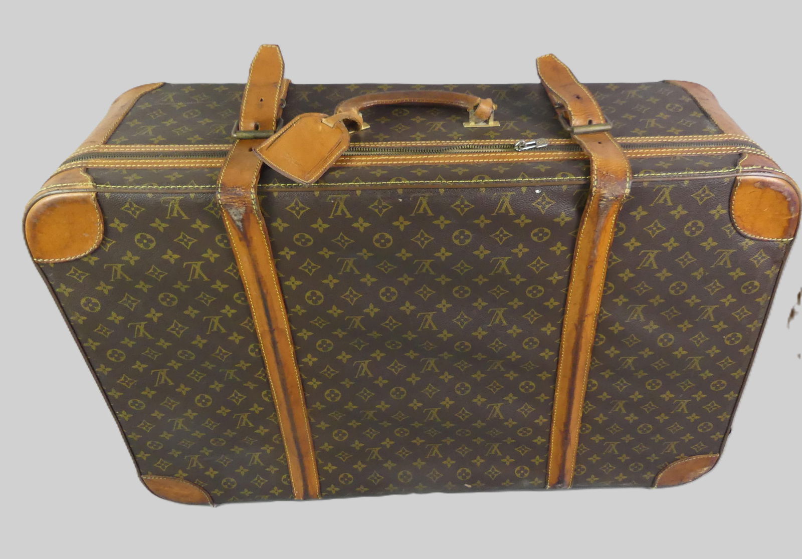 LOUIS VUITTON MONOGRAM SUITCASE: Vintage Louis Vuitton monogram suitcase, 31 x 21 x 10 inches. In good overall condition (with typical wear) with leather straps and working zippers. Has leather tag with Vuitton stamp. Clean
