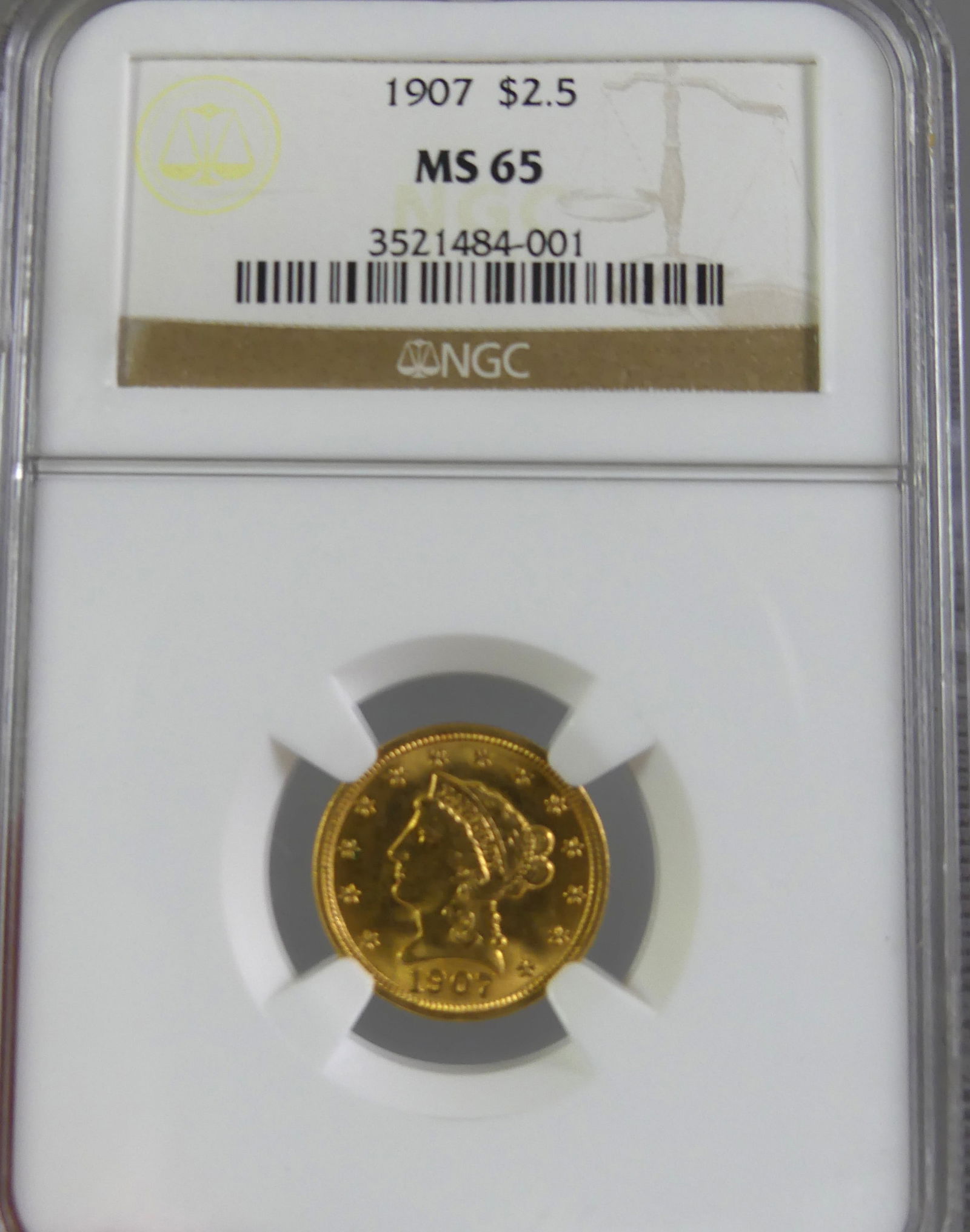 GOLD COIN $2.50 LIBERTY QUARTER EAGLE 1907: Slabbed and graded MS65 by NGC gold coin $2.50 Liberty quarter eagle dated 1907. NOTE: We can ship this item in-house.