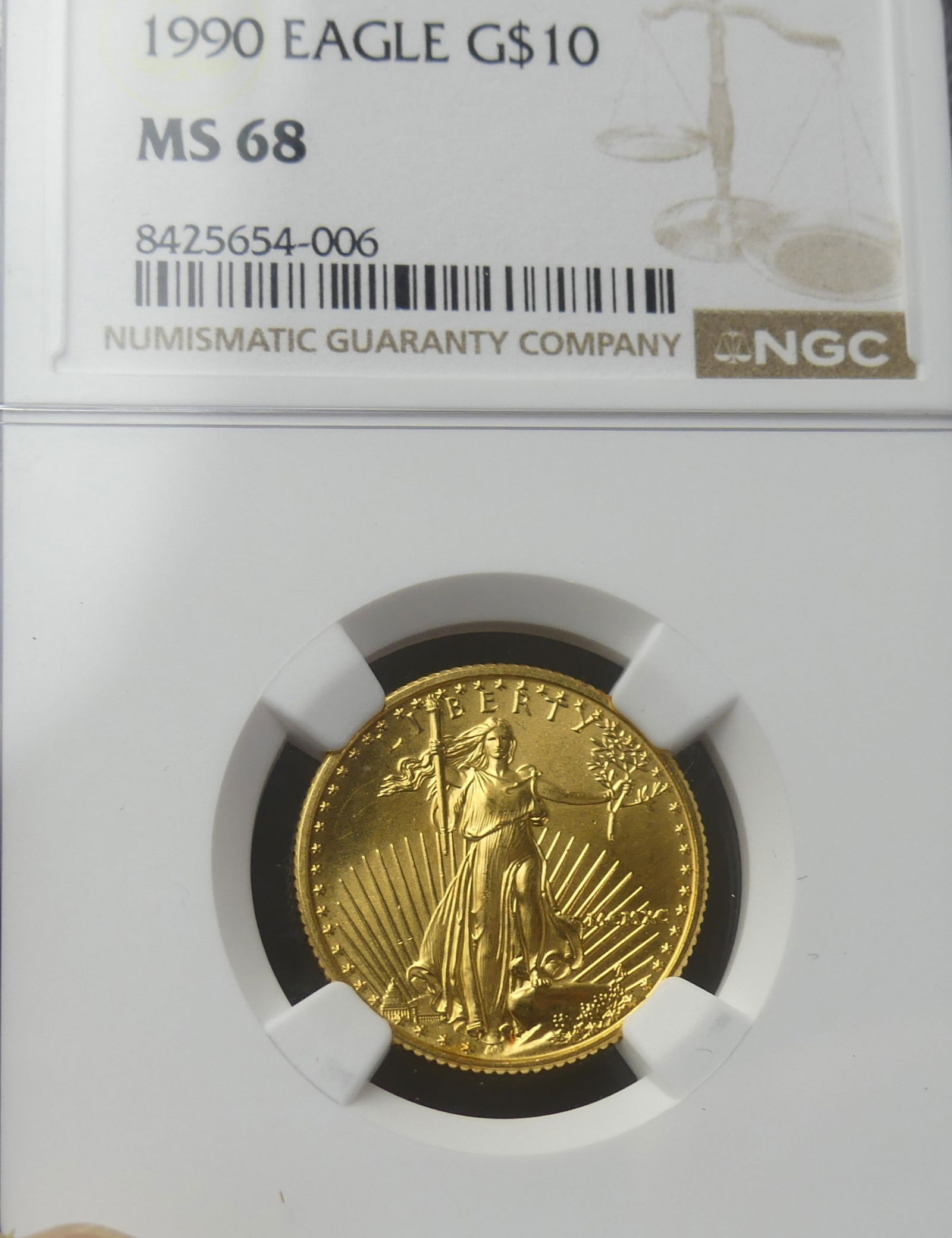 1990 GOLD EAGLE $10 COIN: 1990 Gold Eagle $10 coin (slabbed) with NGC grade of MS68. Content: 1/4 oz .999 gold.