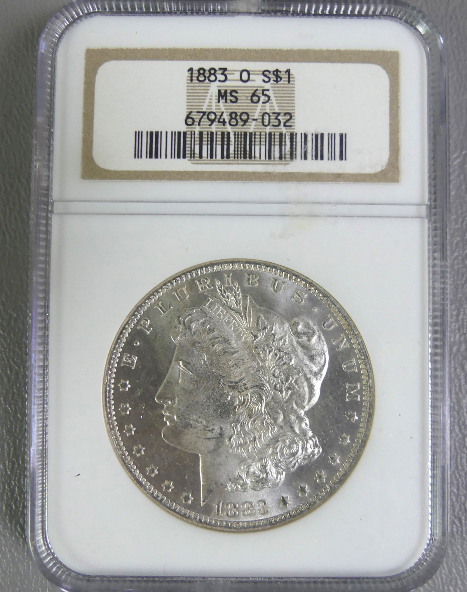 1883-O MORGAN SILVER DOLLAR MS-65: Slabbed and graded 1883-O Morgan silver dollar MS-65. NOTE: We can ship this item in-house.