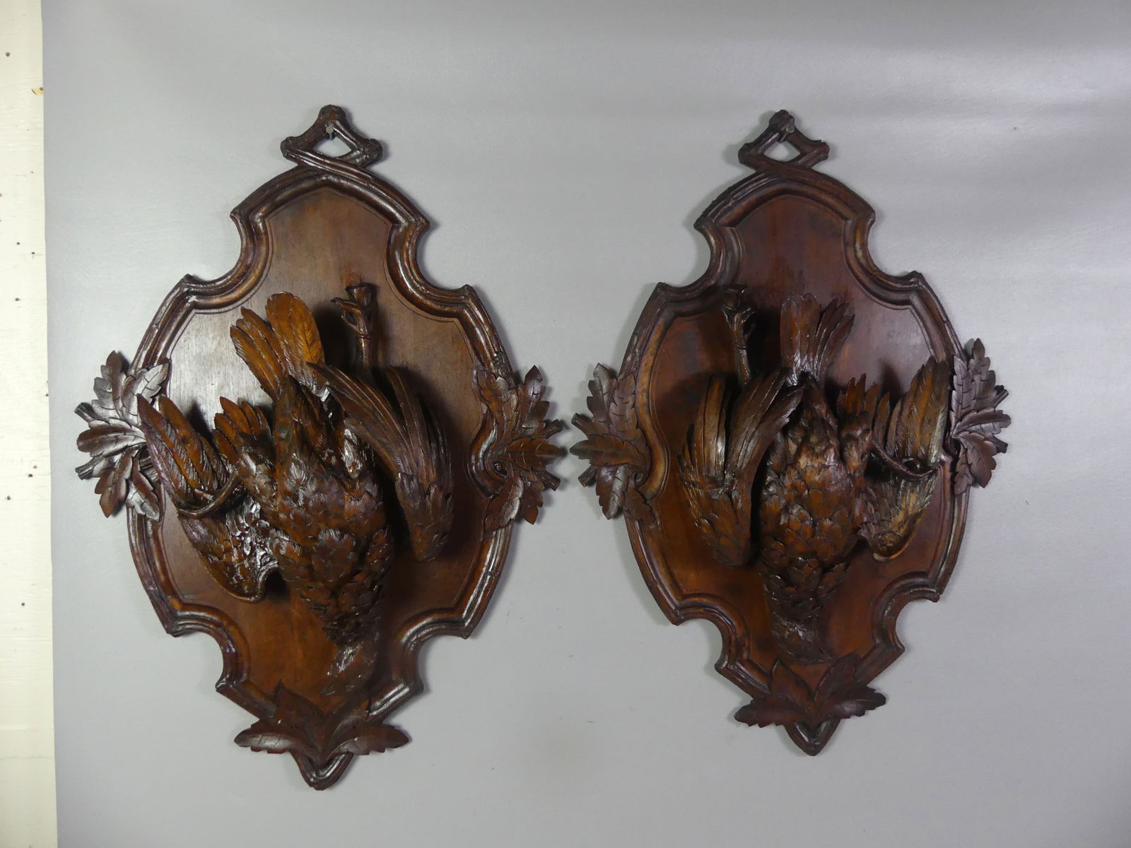 PAIR BLACK FOREST PLAQUES - GAME BIRDS: Pair of Victorian finely carved walnut Black Forest wall plaques of dead game birds. 24 in high x 18 x 4 in deep. VG condition. NOTE: We can ship this item in-house.