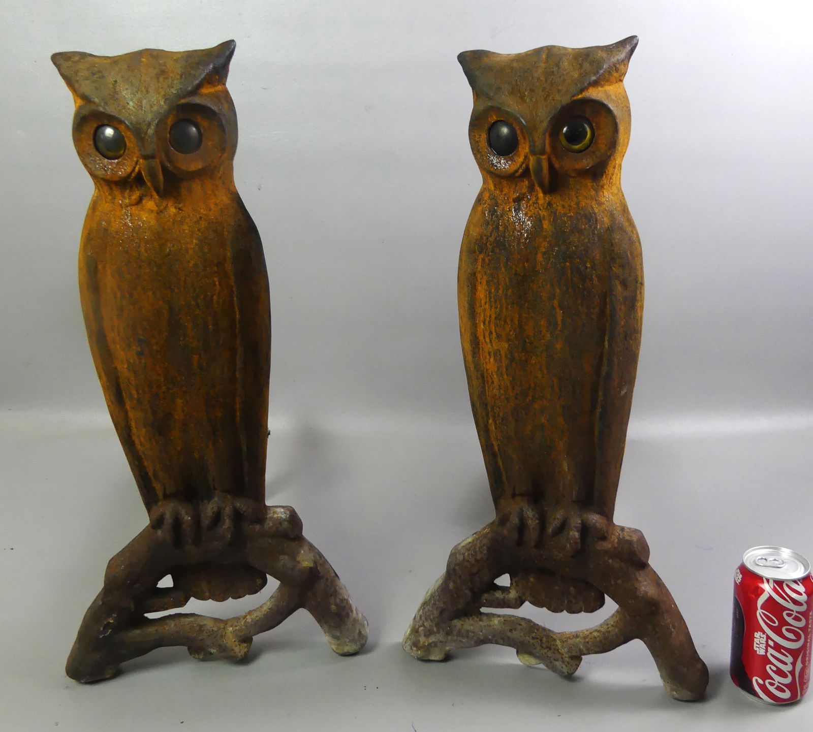 PAIR LARGE IRON OWL ANDIRONS: Pair of large antique andirons in the form of owls with glass eyes. 21.5 x 11 x 15 in deep. No marks. NOTE: We can ship this item in-house.