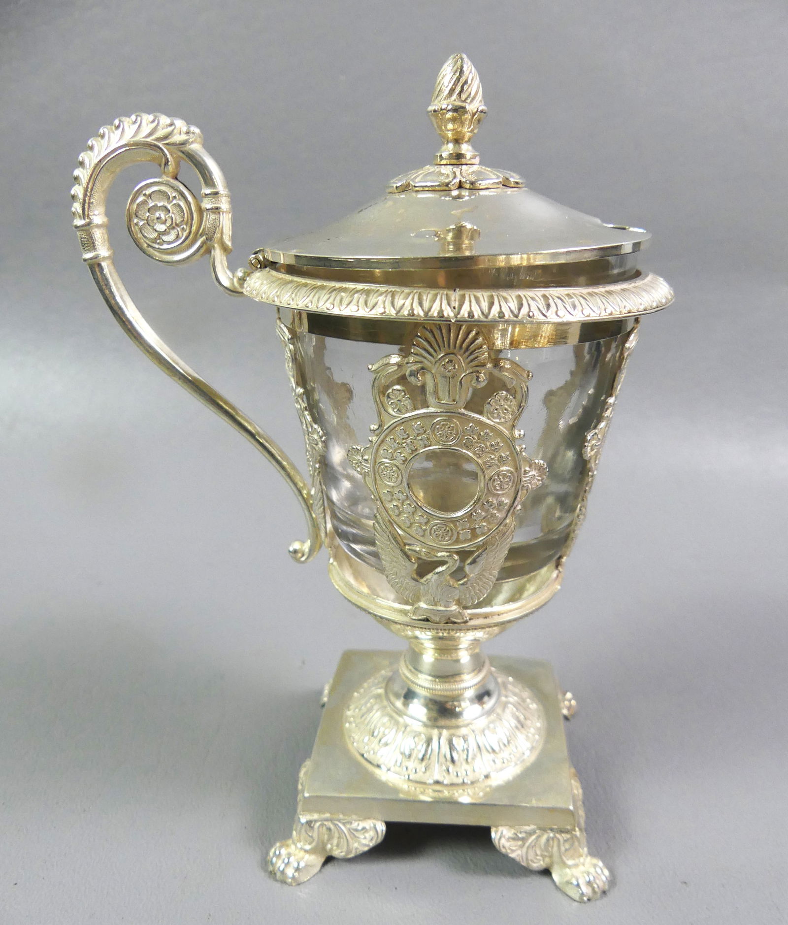 FRENCH SILVER MUSTARD POT: Fine antique French Empire style silver mustard pot with glass insert, paw feet and medallions with swans. Has 3 small hallmarks with portrait heads. Weighs 4.8 ozt without glass container. 5.5 in