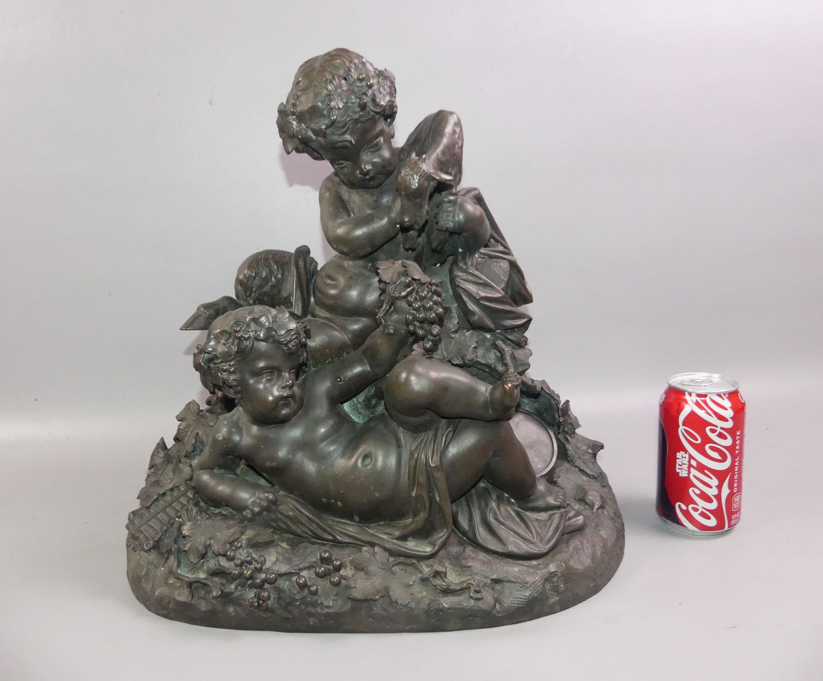 ANTIQUE FRENCH BRONZE - PAN & PUTTO: Large, elaborate 19th century French bronze of Pan holding a goat with a putto eating grapes at his feet. There is a flute on the ground. Unsigned, possibly after Claude Michel Clodion. 15 x 15.5 x