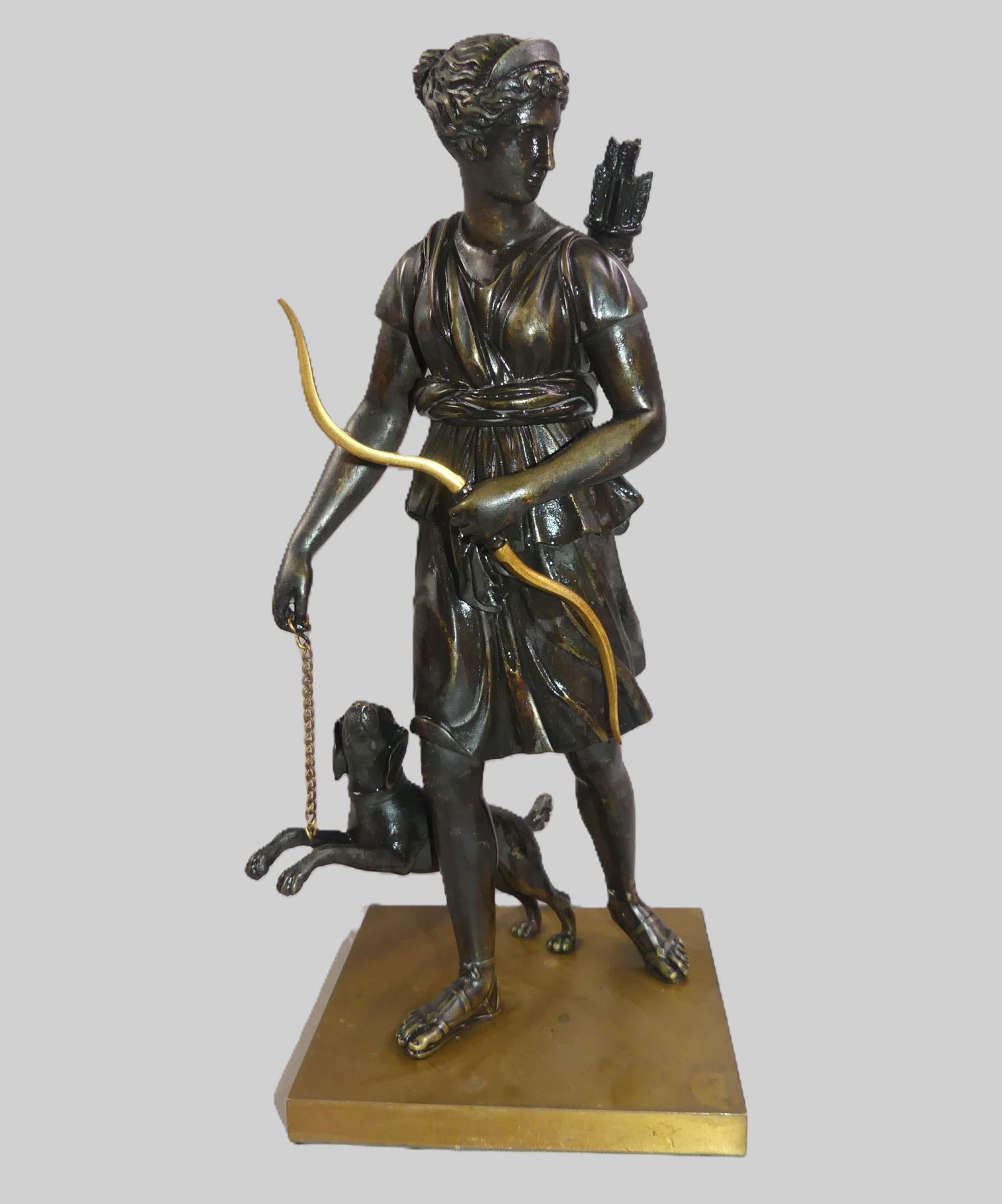 ANTIQUE BRONZE OF DIANA THE HUNTRESS: 19th century French bronze figure of Diana the Huntress carrying bow with dog at her side. Unsigned. 12 in tall x 5 in square. Had been mounted as lamp. NOTE: We can ship this item in-house.