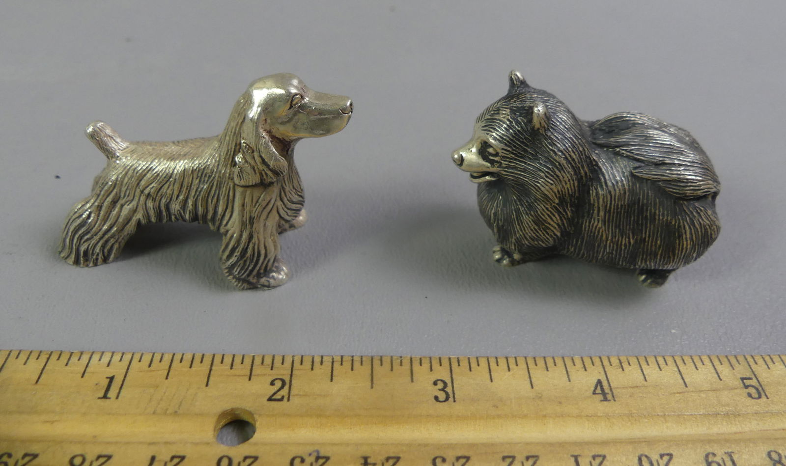 2 KIRK STERLING MINI DOG FIGURES: 2 vintage miniature sterling silver figurines of dogs by S. Kirk & Son from their ANIMAL SPIRITS collection. A Pomeranian dog, 2 x 1.5 inches; and Cocker Spaniel (#1540 in catalog) 2.25 x 1.5 inches.