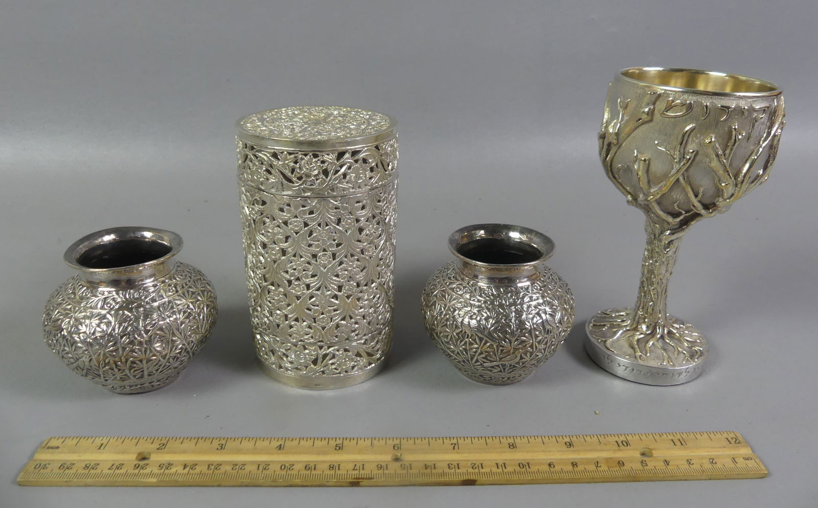 4 PCS MID-EAST SILVER ITEMS: Lot of 4 Middle Eastern silver pieces: Jewish parcel-gilt Tree of Life chalice, 5.75 in, weighted base; reticulated cylindrical container with lid, 5 x 3 in; pair of 2.5 in vases with birds and