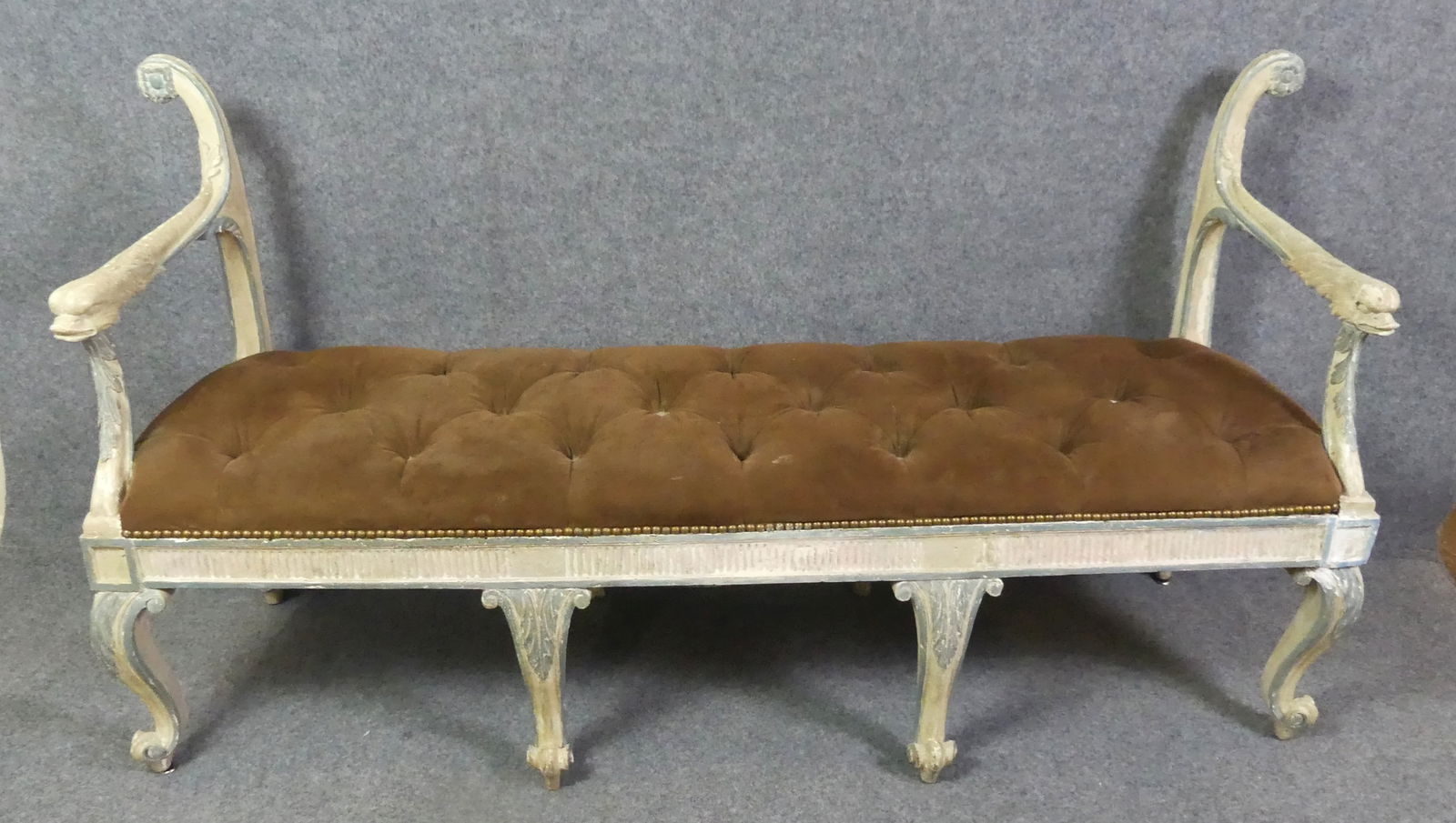 FRENCH PAINTED BENCH: Old painted French Louis XV style backless settee or window bench. Tufted brown felt seat. 5 ft 2 in long x 34 h x 18 deep. Has some minor repair to leg.
