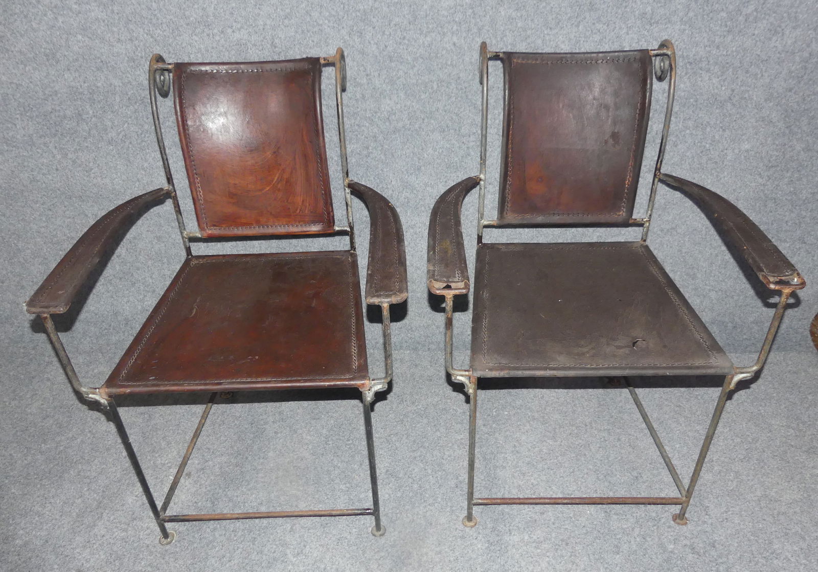 PR. IRON & LEATHER CHAIRS - MATTEO GRASSI: Pair of old iron and leather mid-century armchairs, possibly Matteo Grassi of Italy, 24 in wide by 34.5 h x 18 in deep. Some wear to leather and couple tears on seat.