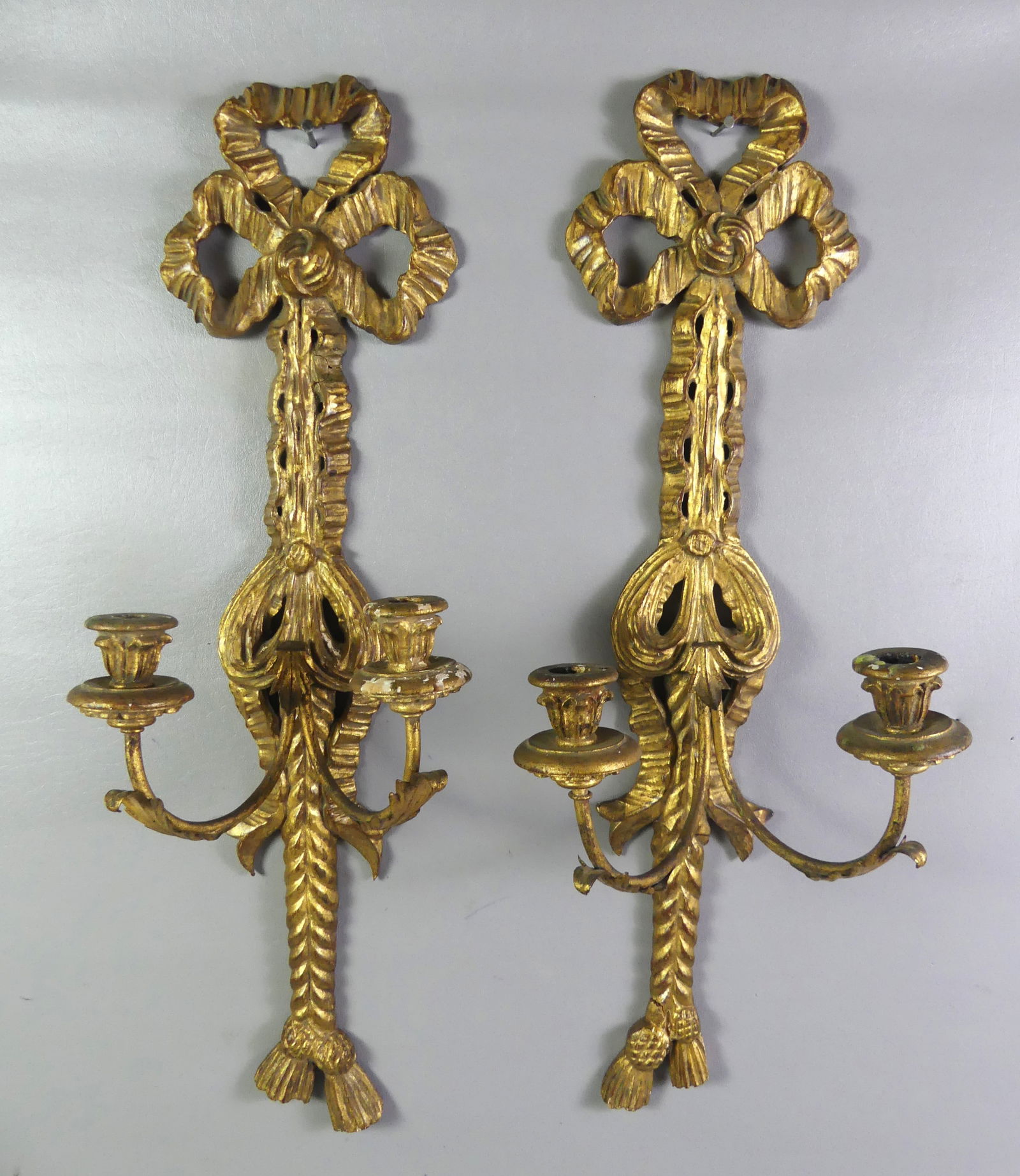 PR. GILTWOOD DOUBLE SCONCES: Pair of giltwood French or Italian double electric wall sconces with ribbon design. 26.5 in high. Good condition. NOTE: We can ship this item in-house.