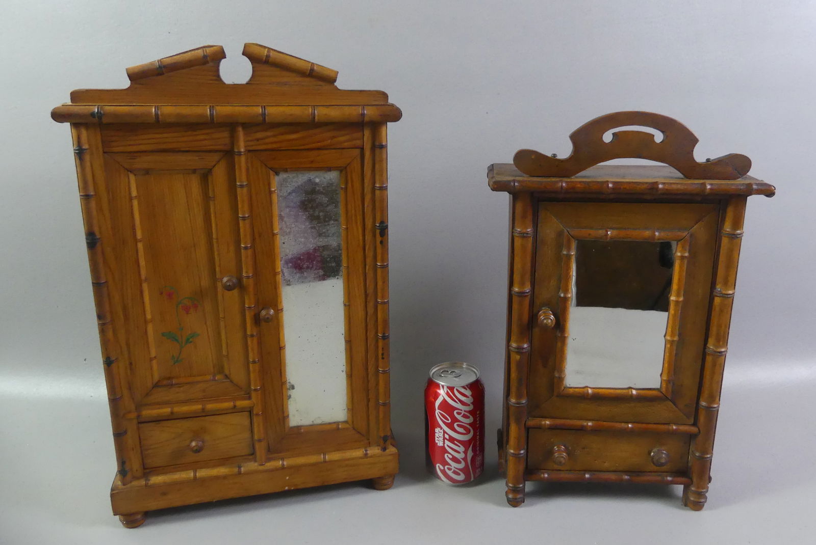 2 MINI BAMBOO ARMOIRES: 2 Victorian miniature pine bamboo style armoires: Two door with painted flower and single drawer, 18 x 11 x 4.5 in; One door and one drawer armoire, 16 x 8 x 3.5 in. NOTE: We can ship this item