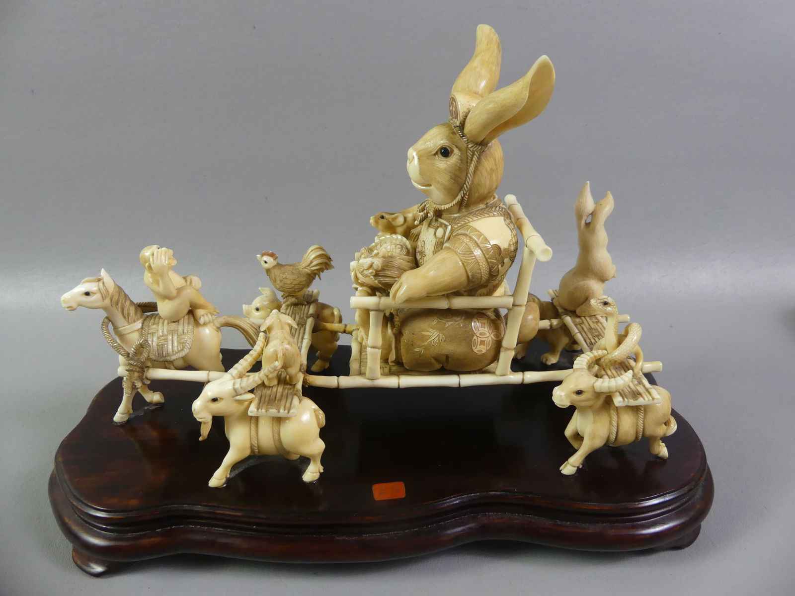 SUPERB JAPANESE FIGURAL GROUP - RABBIT EMPEROR: A wonderful & whimiscal, finely carved Japanese figural group (okimono) of a royal animal procession with rabbit as emperor being carried in a sedan chair. Probably made to commemorate the year of